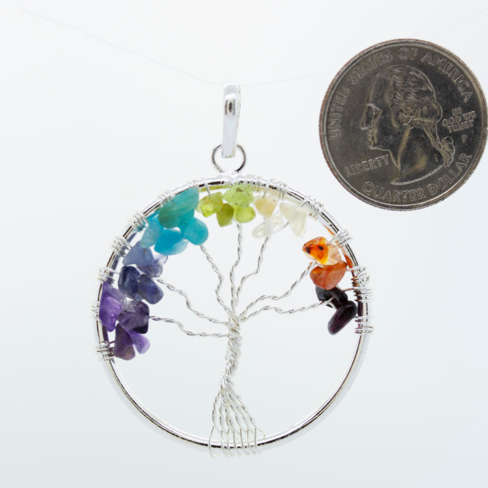 
                  
                    Super Silver's Wire-Wrapped Chakra Tree of Life Pendant adorned with chakra stones.
                  
                