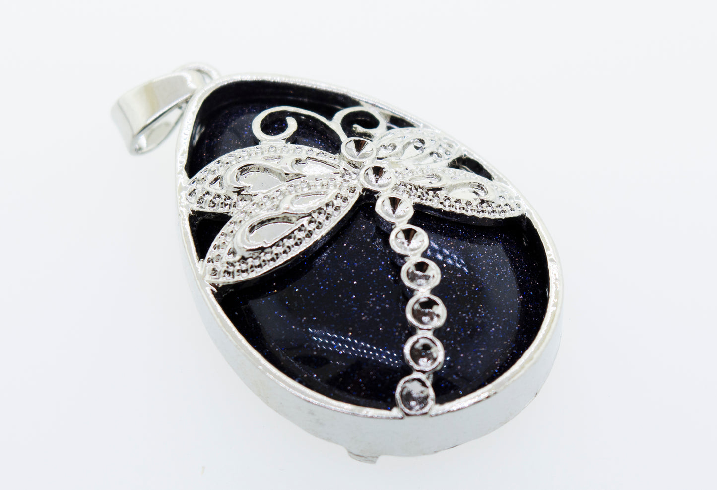 A Super Silver Teardrop Stone pendant with a dragonfly adorned with a teardrop shaped black stone.