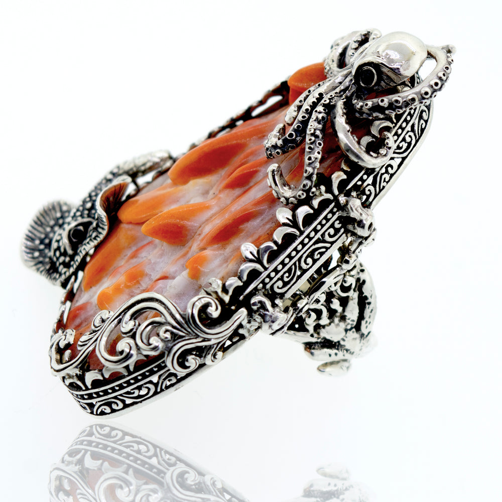 
                  
                    A Handcrafted Spiny Shell Designer Ring with an orange stone on a white surface.
                  
                