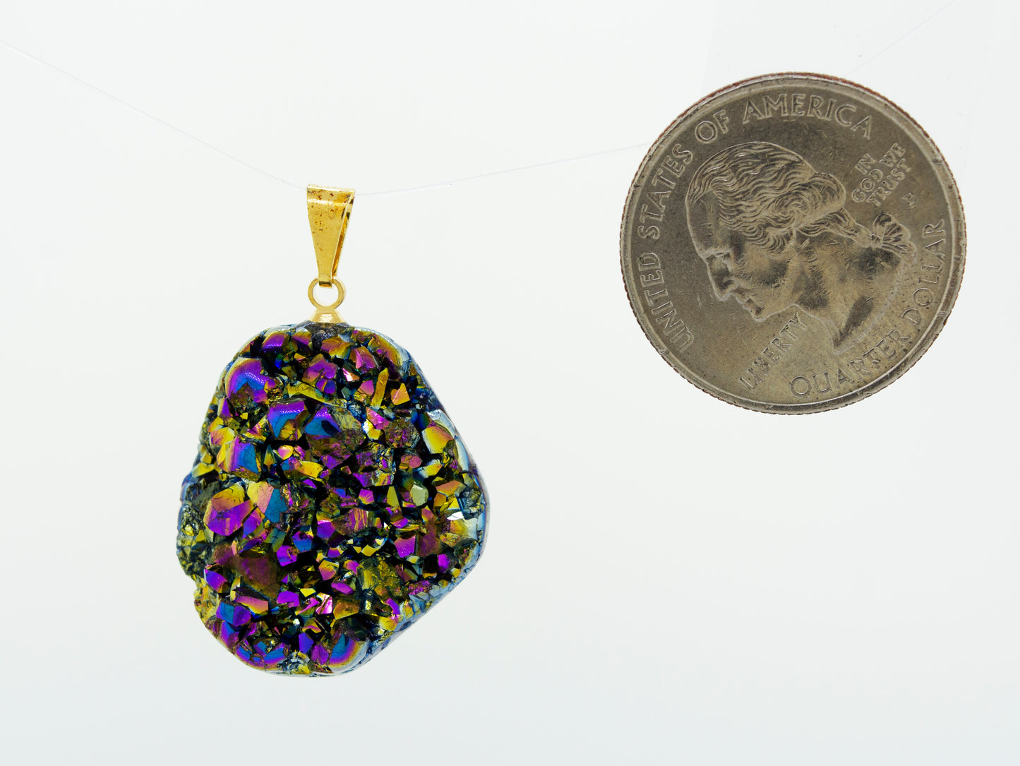 A Super Silver Dazzling Druzy Pendant with a dime next to it.