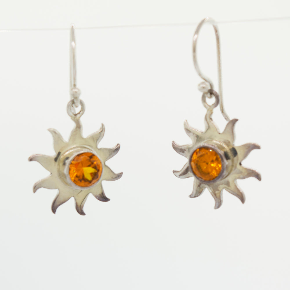 A pair of Super Silver Citrine Sunburst Earrings with radiant amber stones in a sunburst setting.