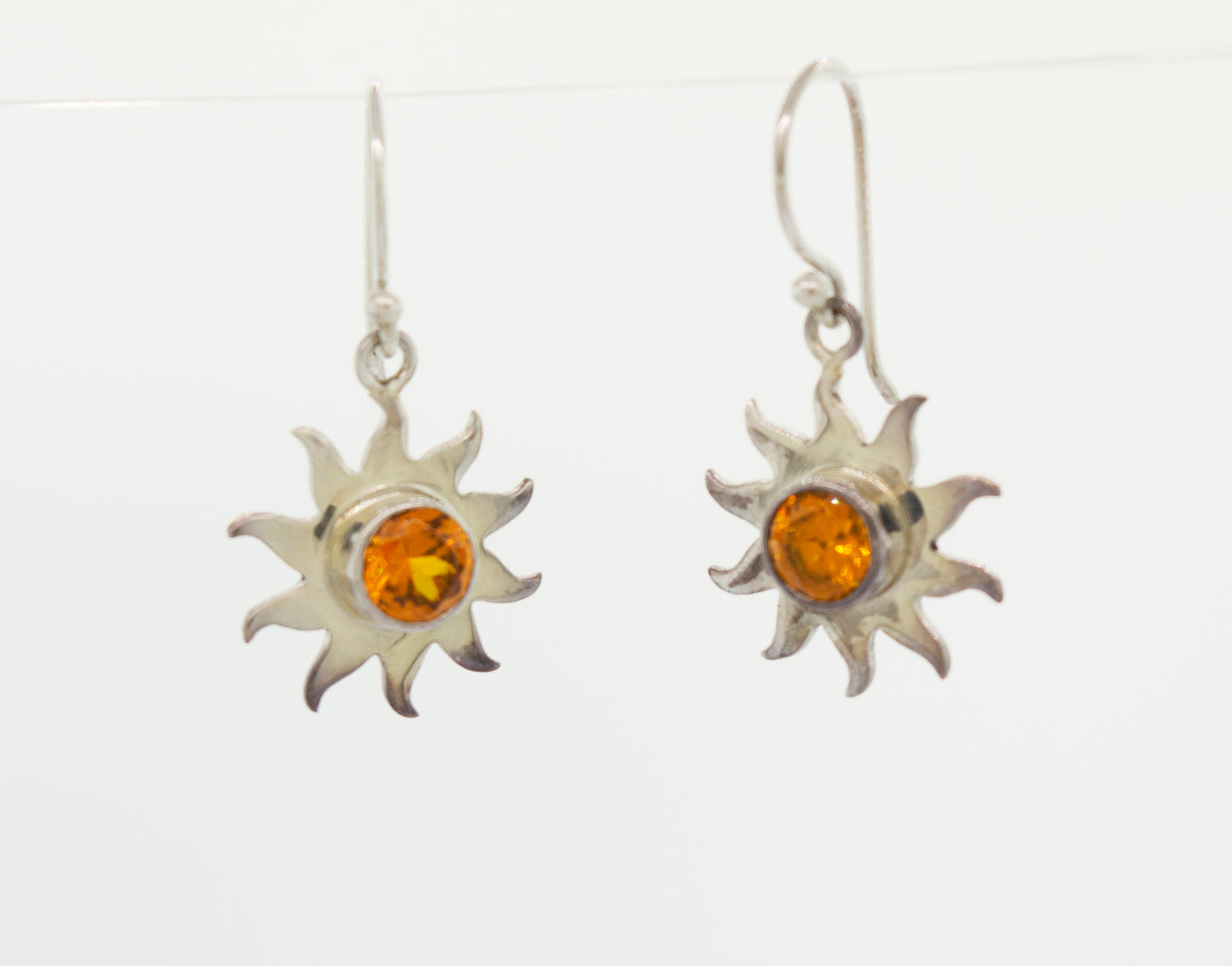 A pair of Super Silver Citrine Sunburst Earrings with radiant amber stones in a sunburst setting.