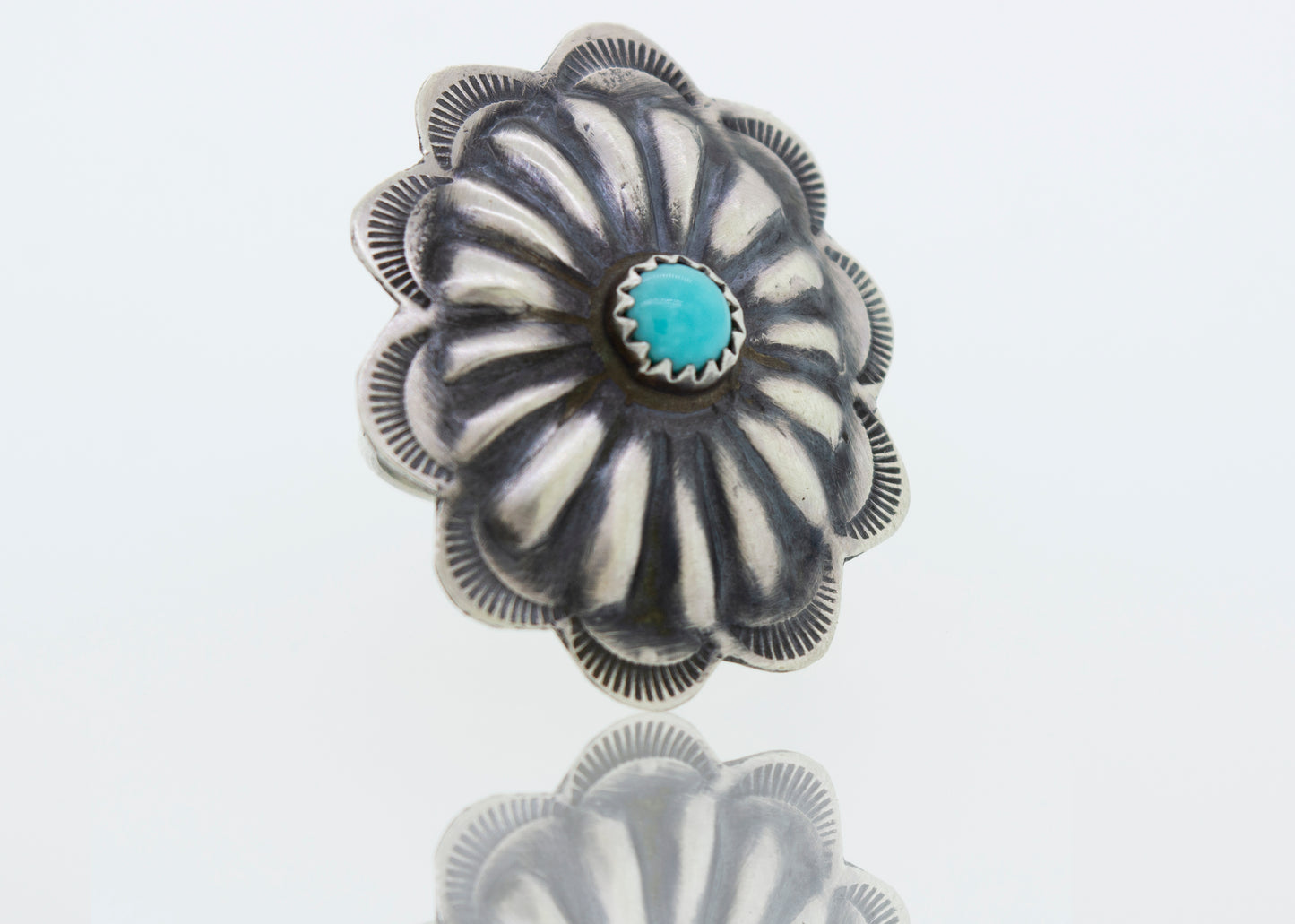 A cultural silver Native American Turquoise Flower ring.