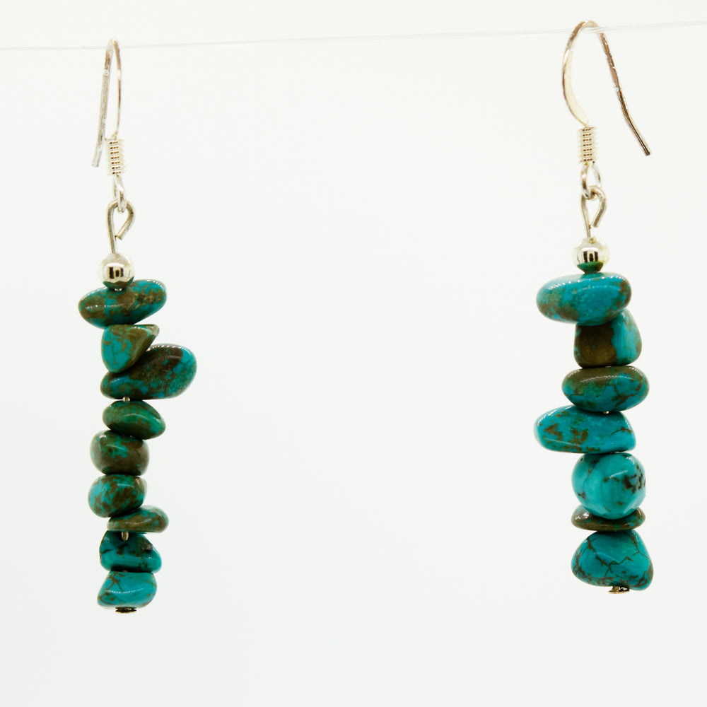 
                  
                    A pair of Super Silver American Made Colorado Turquoise earrings on a white background.
                  
                