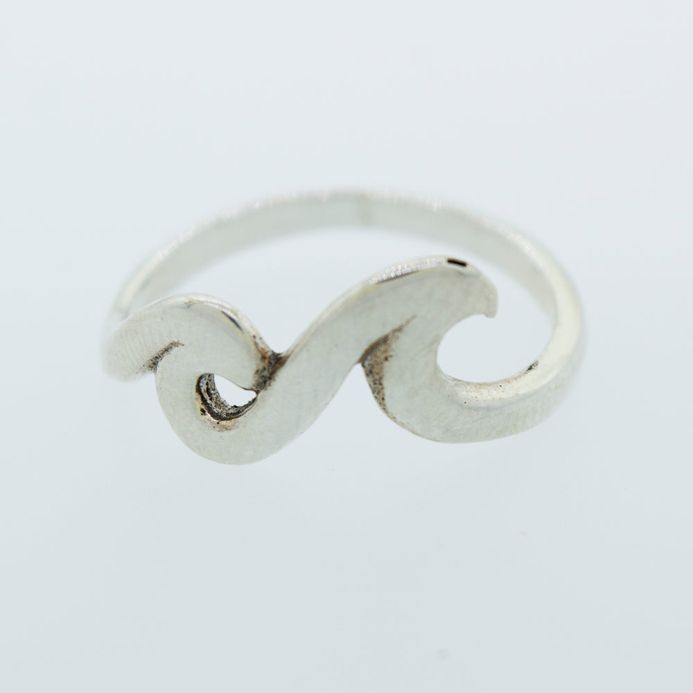 
                  
                    A sterling silver Two Waves Ring with a wave design on it.
                  
                