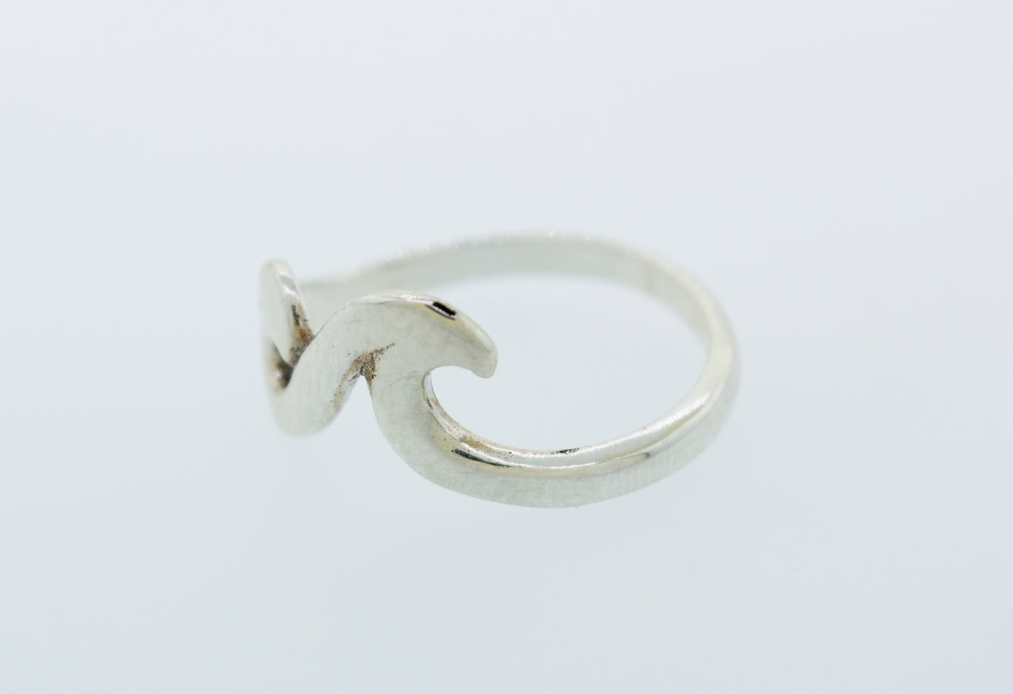 
                  
                    A minimalist silver Two Waves Ring with a modern wave design, inspired by the coastal beauty of Santa Cruz.
                  
                