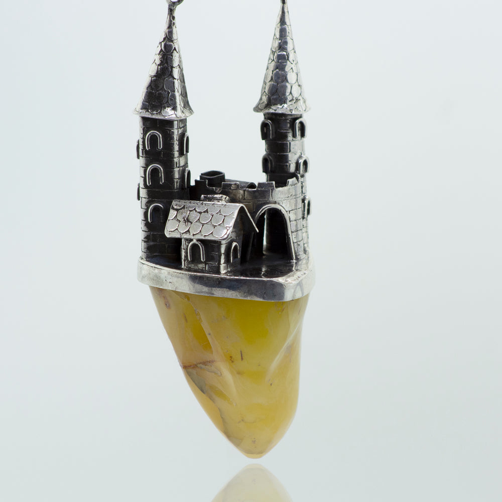 A Beautiful Designer Amber Necklace with a Butterscotch Amber rock and a castle on it, from Super Silver.