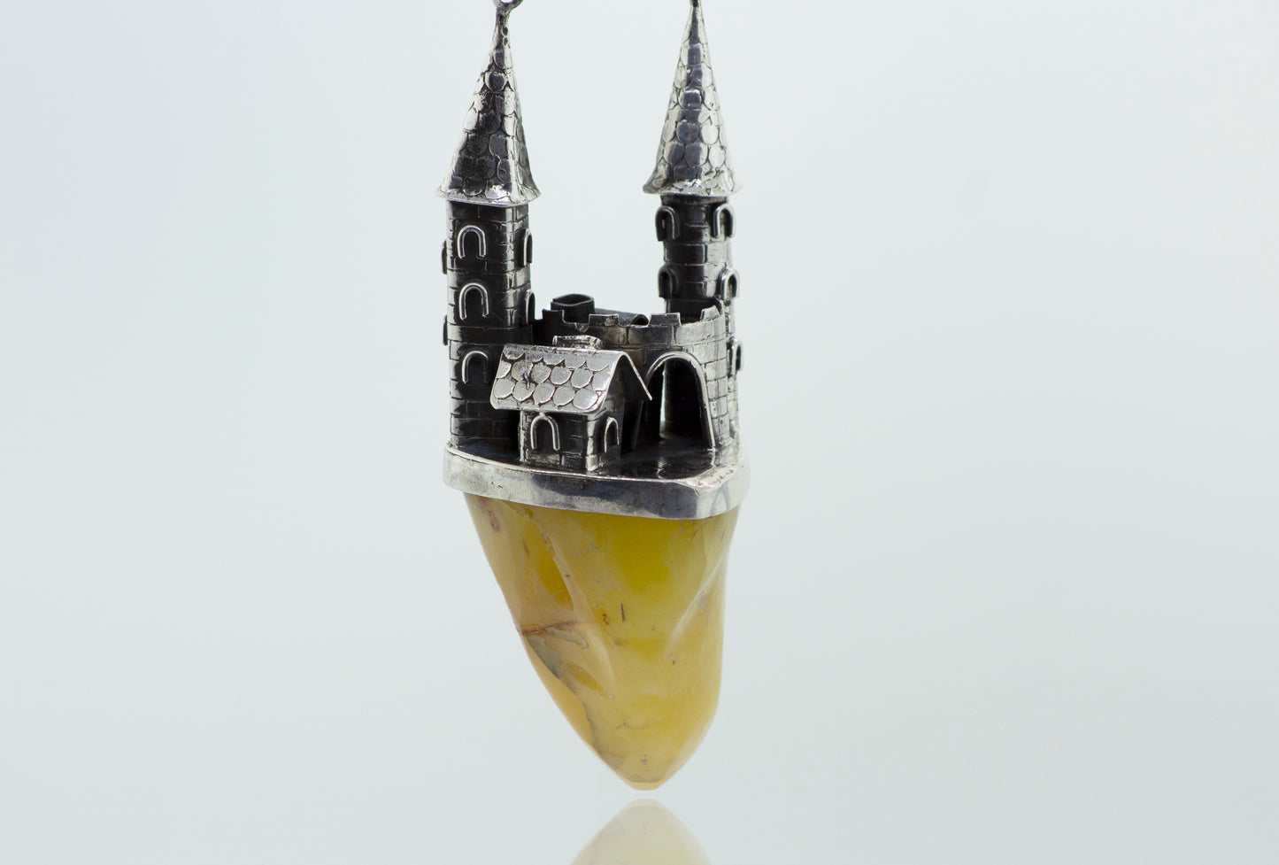 A Beautiful Designer Amber Necklace with a Butterscotch Amber rock and a castle on it, from Super Silver.