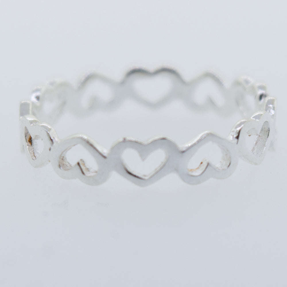 
                  
                    A minimalist Open Heart Band Ring with hearts on it.
                  
                