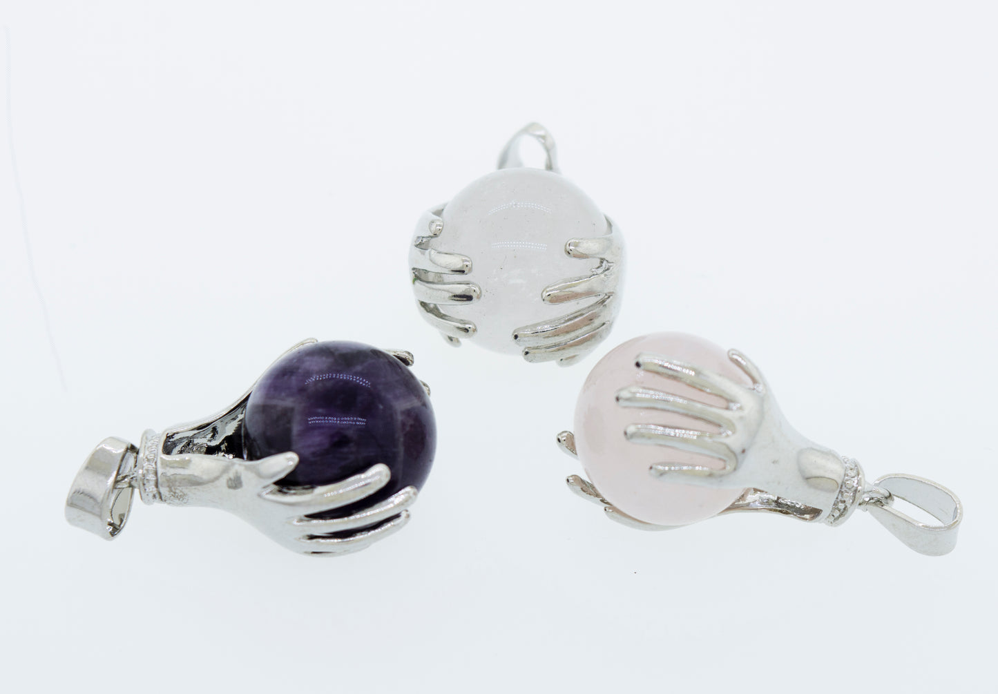 
                  
                    Three Super Silver Sphere Crystal Pendants adorned with pink, purple, and green stones.
                  
                