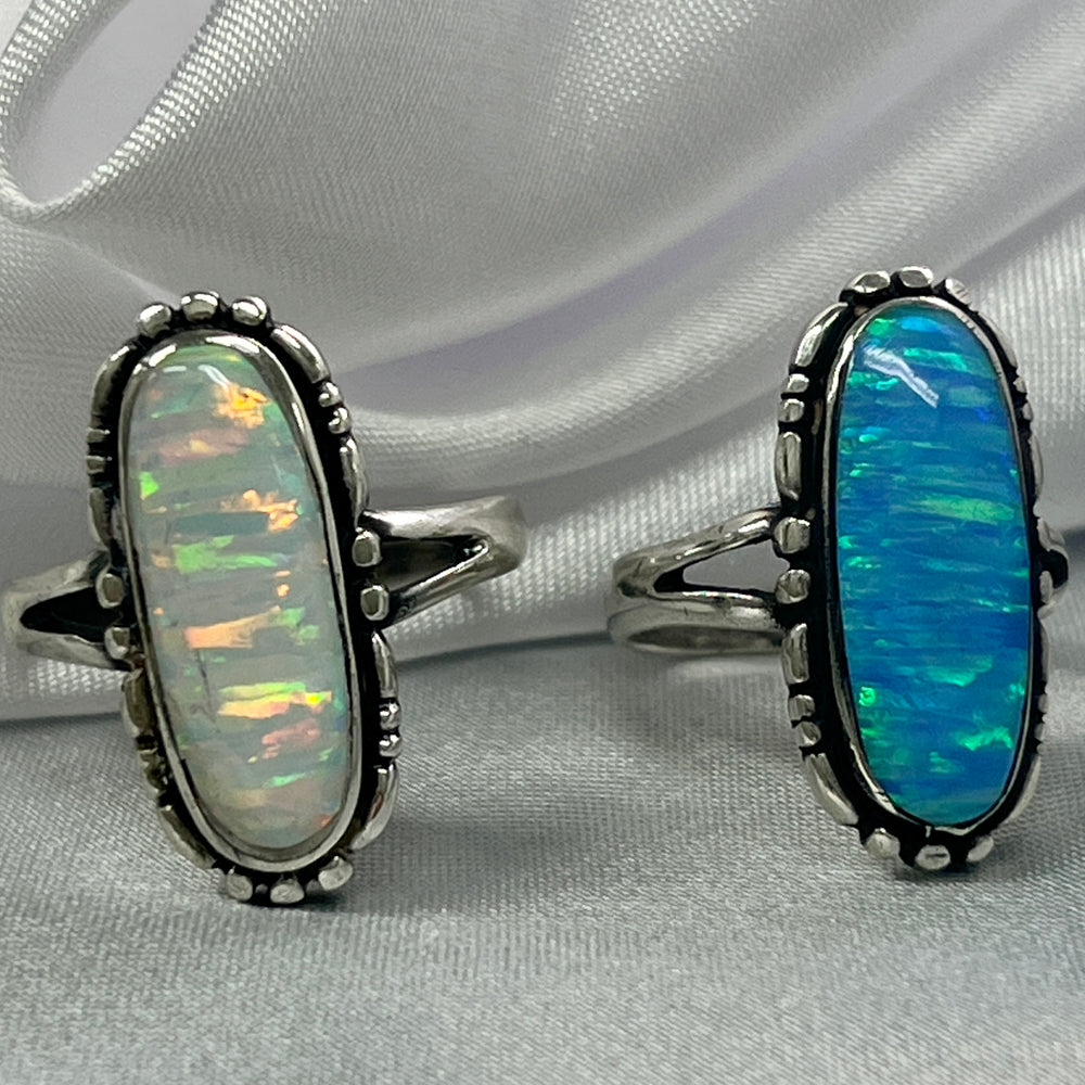 
                  
                    Two American Made Oval Opal Rings by Super Silver on a white cloth.
                  
                