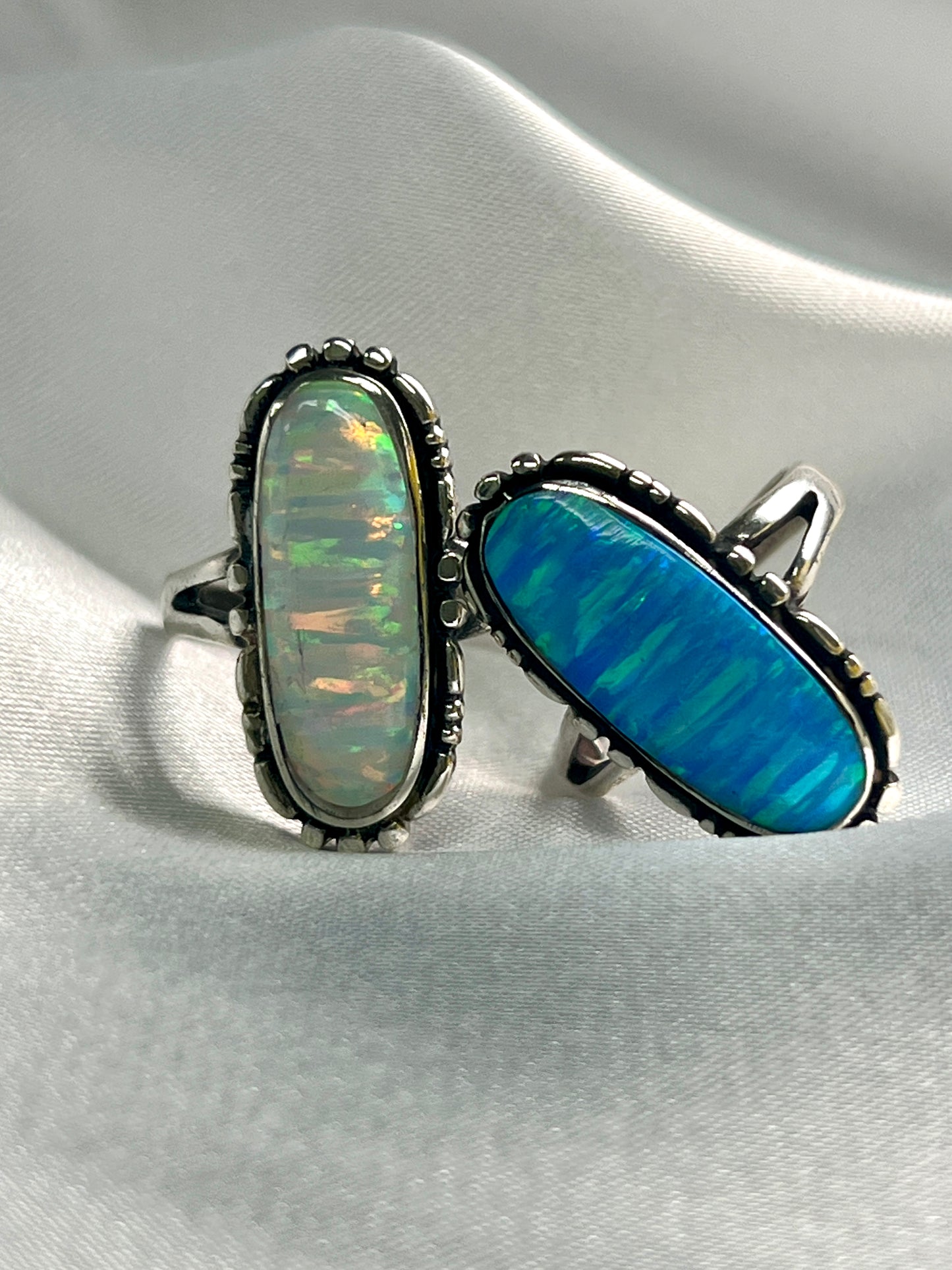 Super Silver's American Made Oval Opal Ring with a southwestern-styled design, resting on a white cloth.