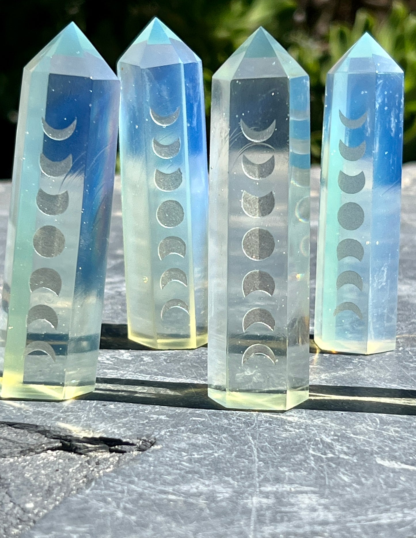 
                  
                    A group of Opalite Obelisks with Moon Phases for decor.
                  
                