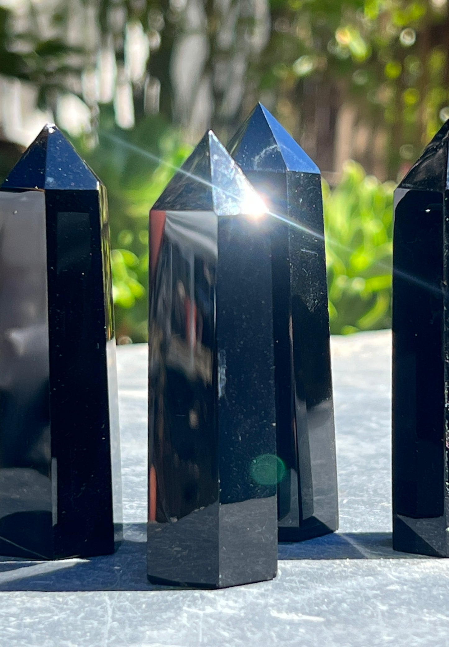 
                  
                    Three Black Obsidian Obelisks sitting on a table.
                  
                