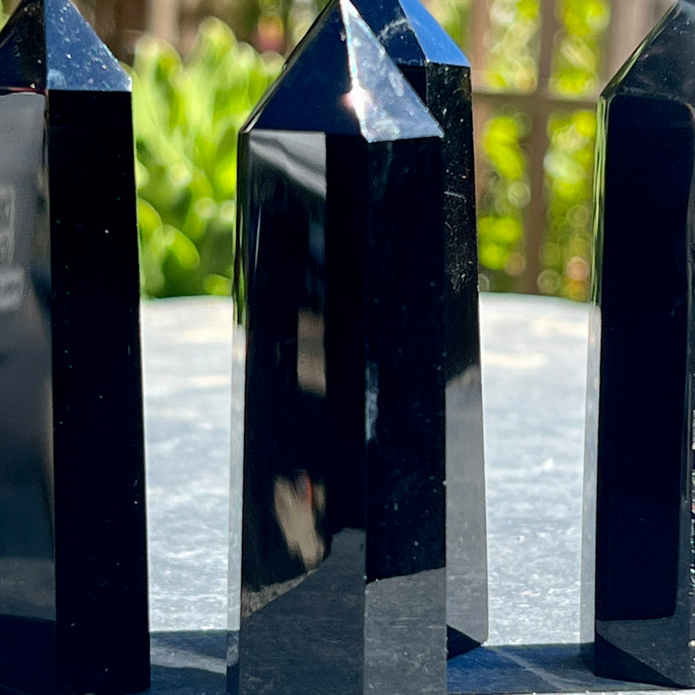 
                  
                    Three Black Obsidian Obelisks used as decor sitting on a table.
                  
                
