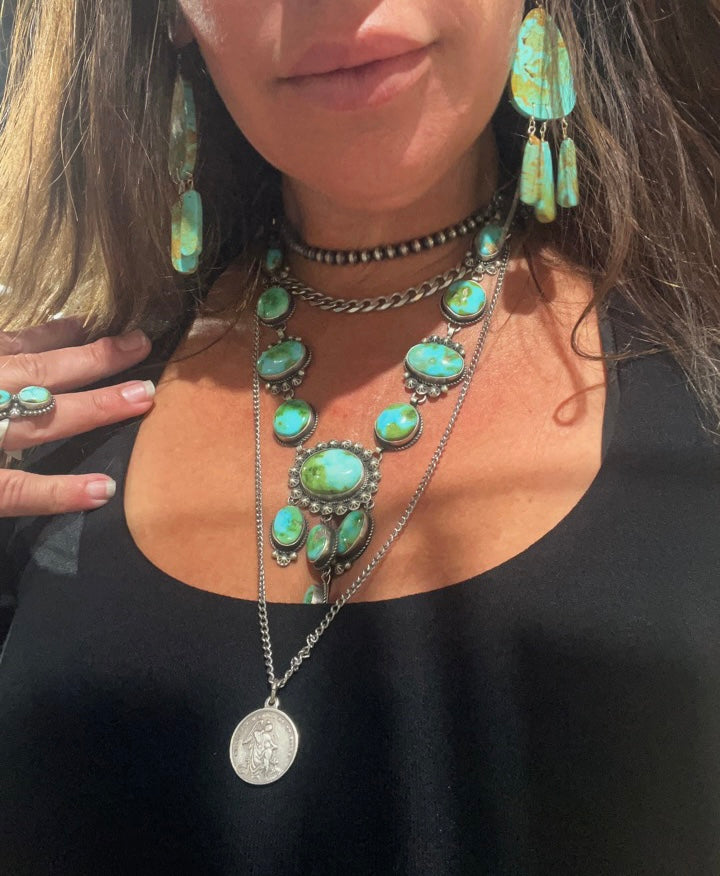 
                  
                    A woman wearing a Super Silver Navajo Pearl Necklace exudes a vintage vibe.
                  
                