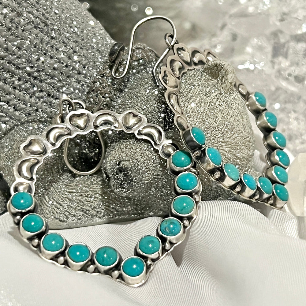 
                  
                    Super Silver's Statement Handmade Turquoise Earrings with a touch of southwestern elegance and silver hoops.
                  
                