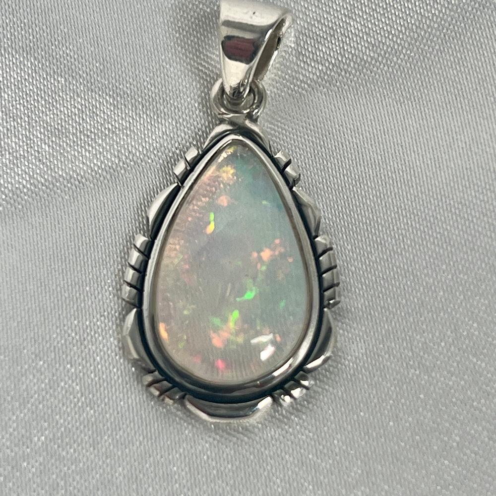 
                  
                    A Super Silver statement piece pendant featuring a stunning Ethiopian Opal Teardrop Shaped Pendant with Detailed Setting.
                  
                