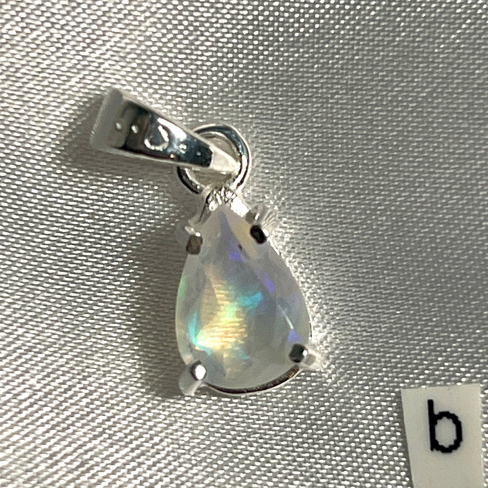 
                  
                    A Dainty Prong Set Facet Cut Teardrop Shaped Ethiopian Opal Pendant made of sterling silver by Super Silver.
                  
                