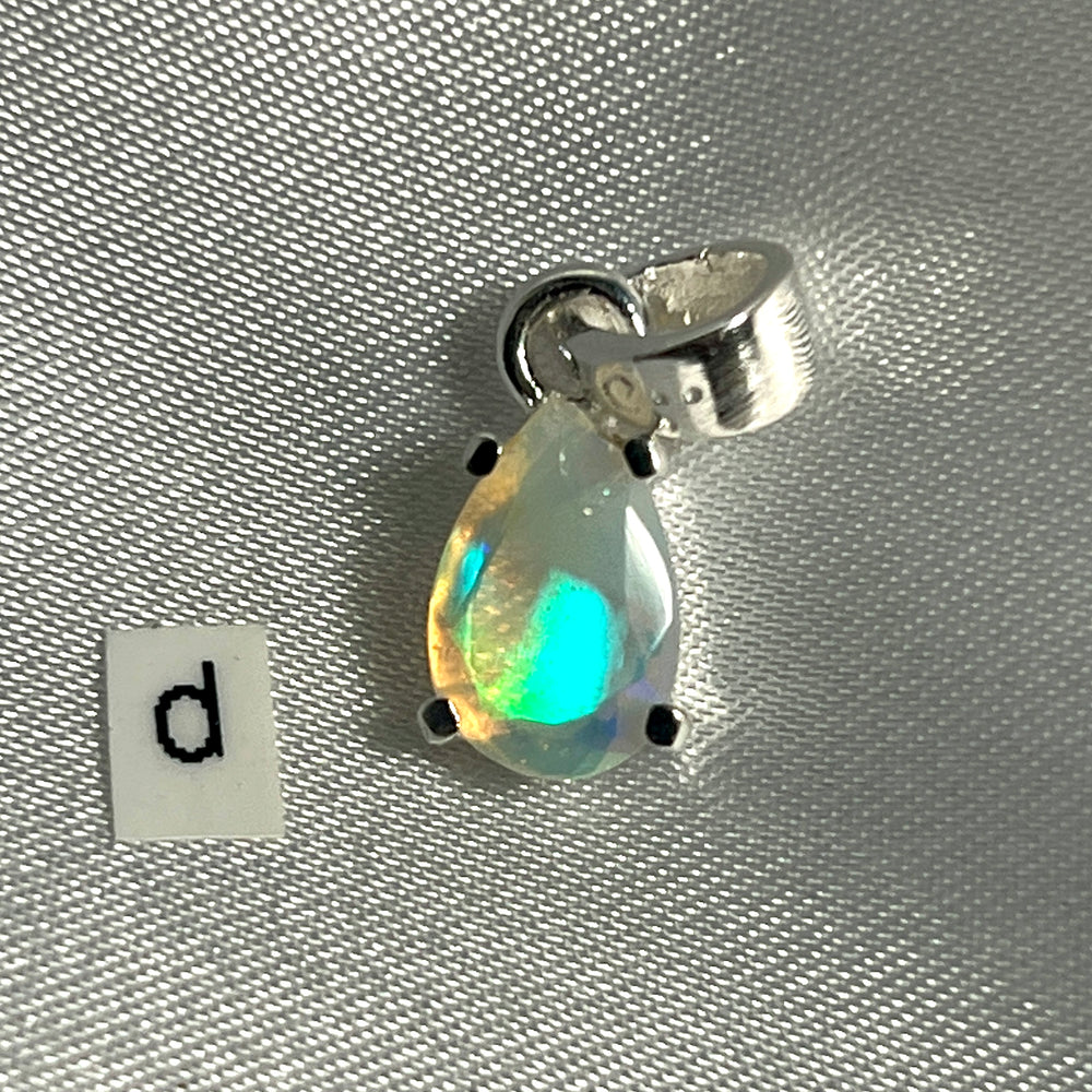 
                  
                    A stunning Dainty Prong Set Facet Cut Teardrop Shaped Ethiopian Opal Pendant with the letter d crafted in Super Silver.
                  
                