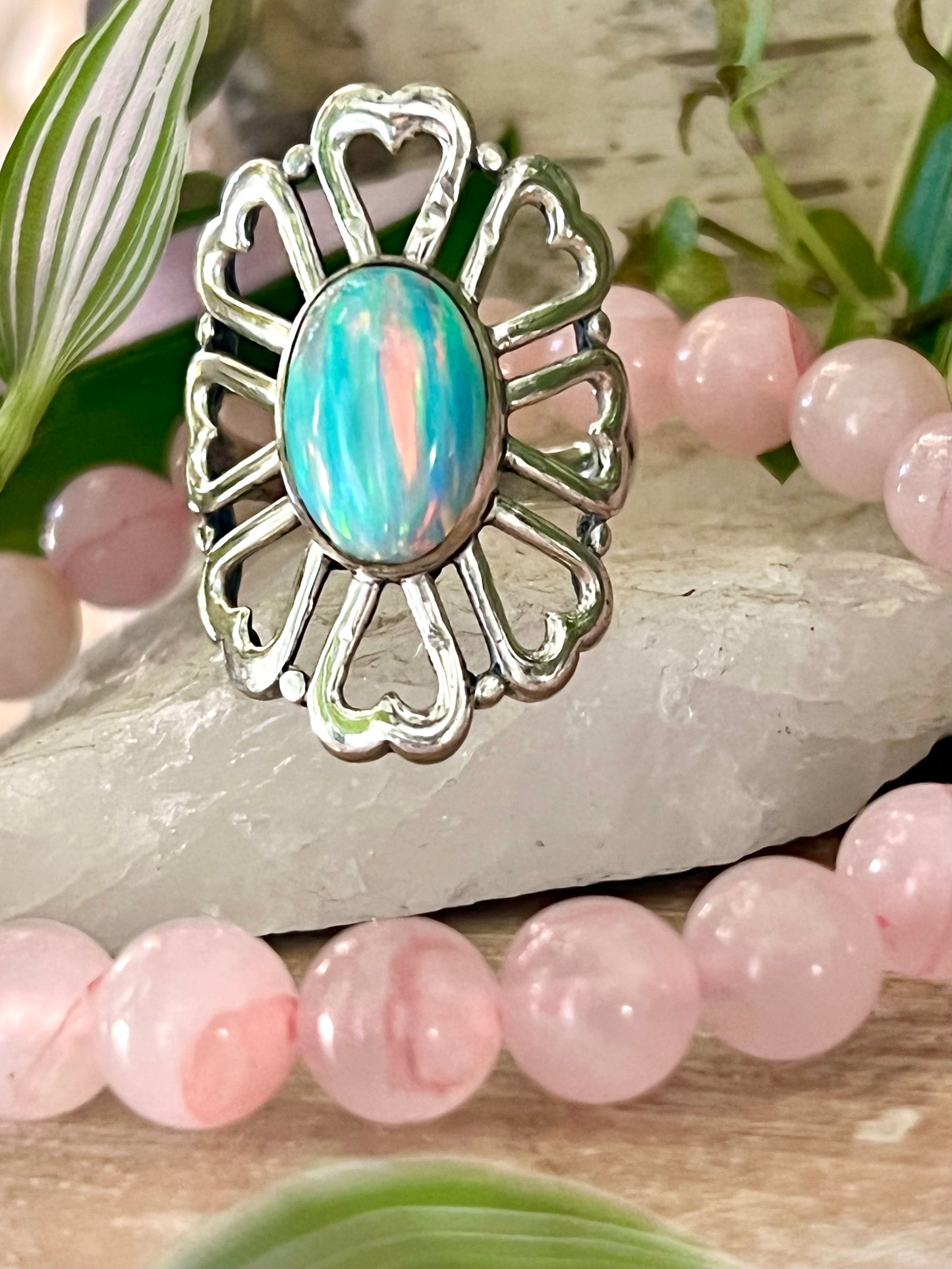 
                  
                    A handcrafted Super Silver American Made Opal Flower Ring with Heart Shaped Petals adorned by pink beads.
                  
                