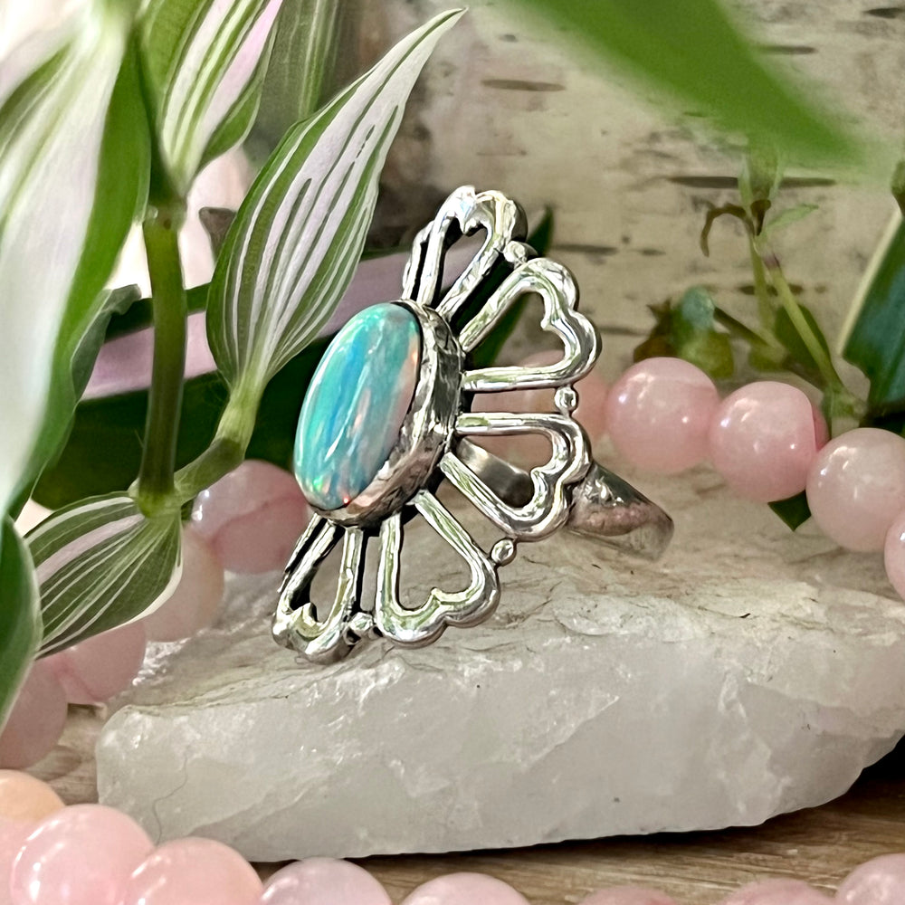 
                  
                    A Super Silver American Made Opal Flower Ring with Heart Shaped Petals, featuring a stunning opal stone and delicate pink beads, and a beautiful flower design.
                  
                