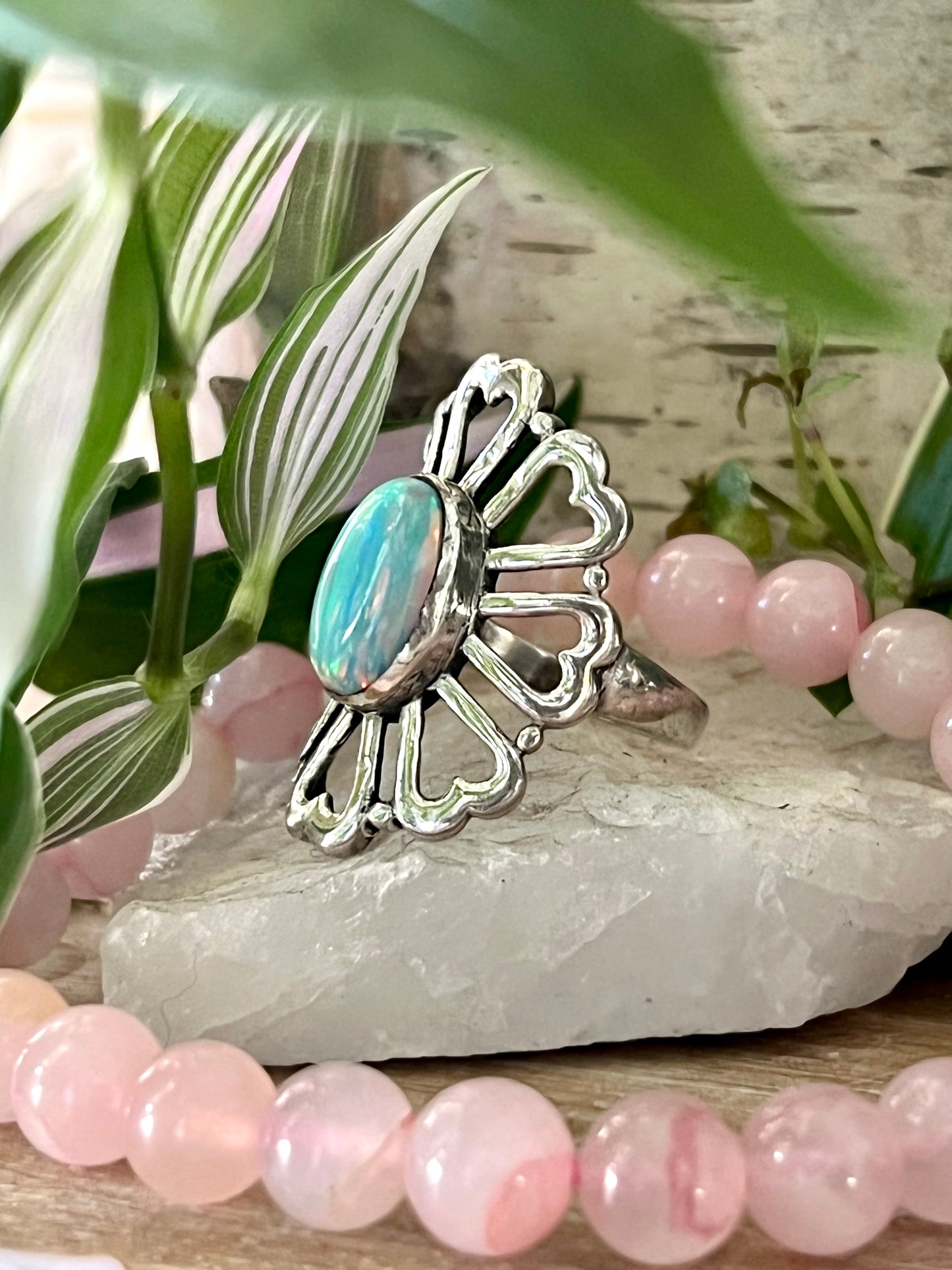 
                  
                    A Super Silver American Made Opal Flower Ring with Heart Shaped Petals, featuring a stunning opal stone and delicate pink beads, and a beautiful flower design.
                  
                