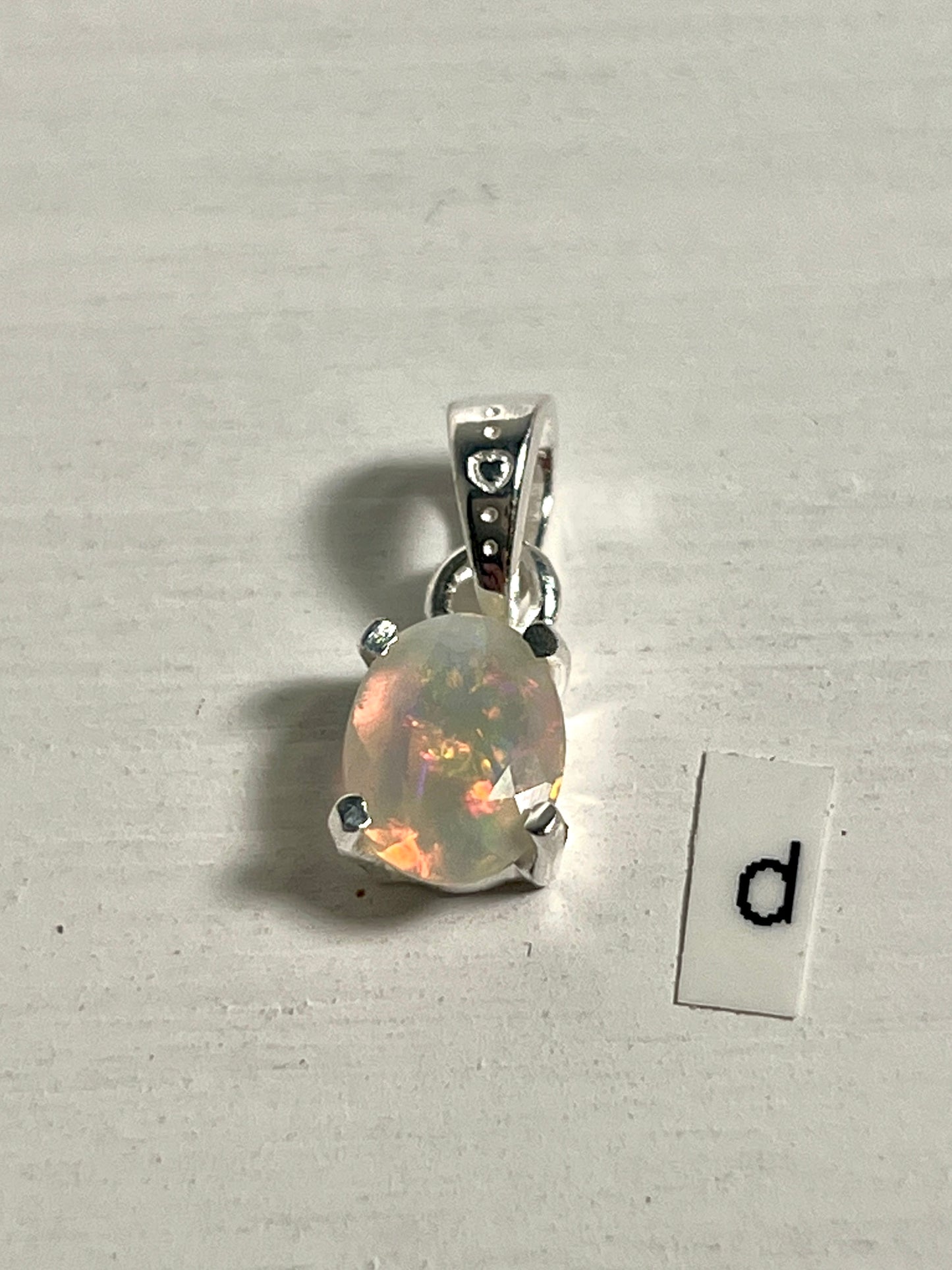 
                  
                    A Tiny Facet Cut Prong Set Ethiopian Opal Pendant from Super Silver set in .925 sterling silver.
                  
                
