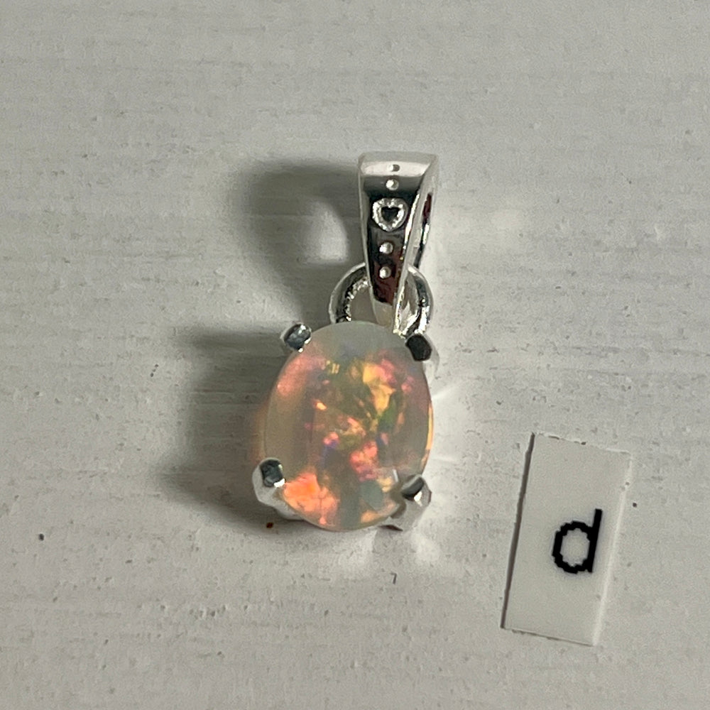 
                  
                    A Tiny Facet Cut Prong Set Ethiopian Opal Pendant in .925 sterling silver with the letter "d" elegantly displayed from Super Silver.
                  
                