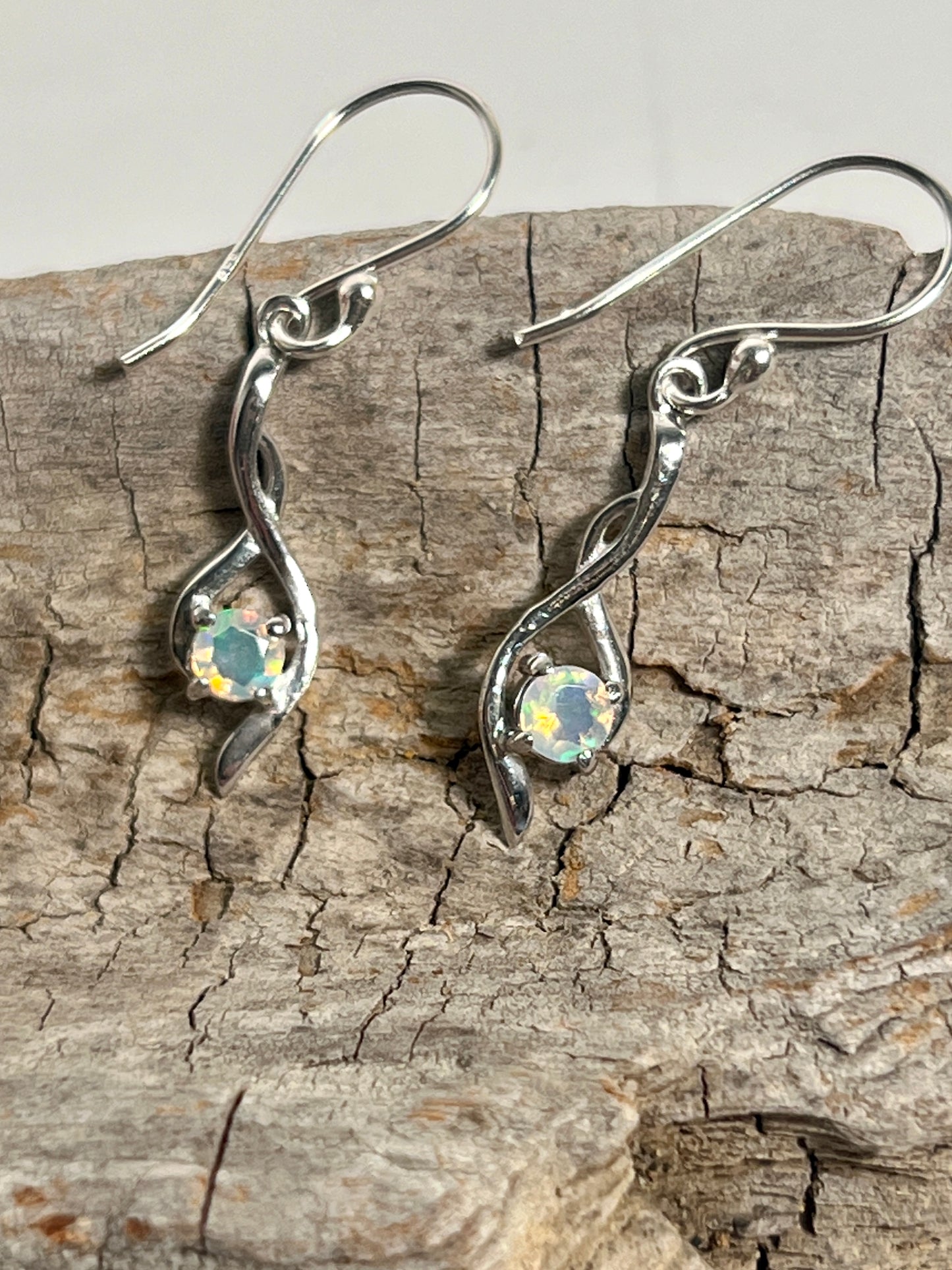 
                  
                    Modern Ethiopian Opal Super Silver dangle earrings exuding glamour.
                  
                