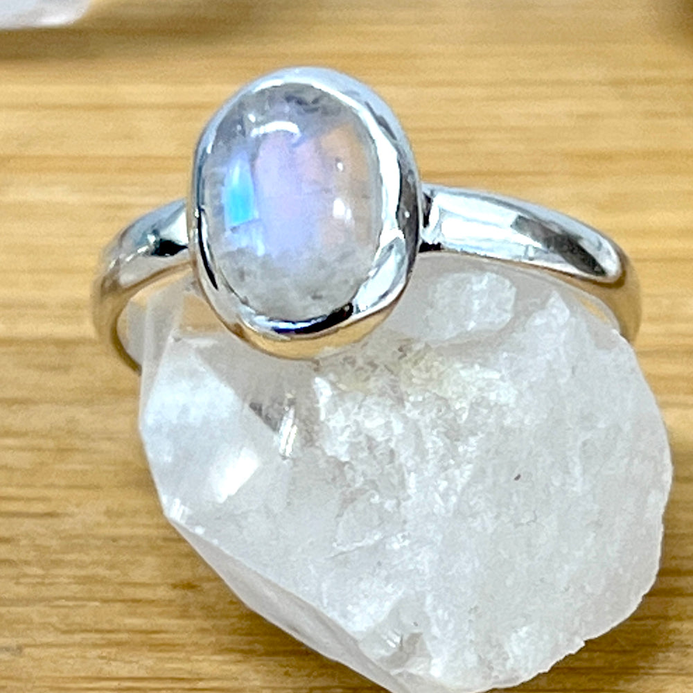 
                  
                    A sterling silver Simple Oval Moonstone Or Labradorite ring with a minimalist design featuring a moonstone atop a rock.
                  
                