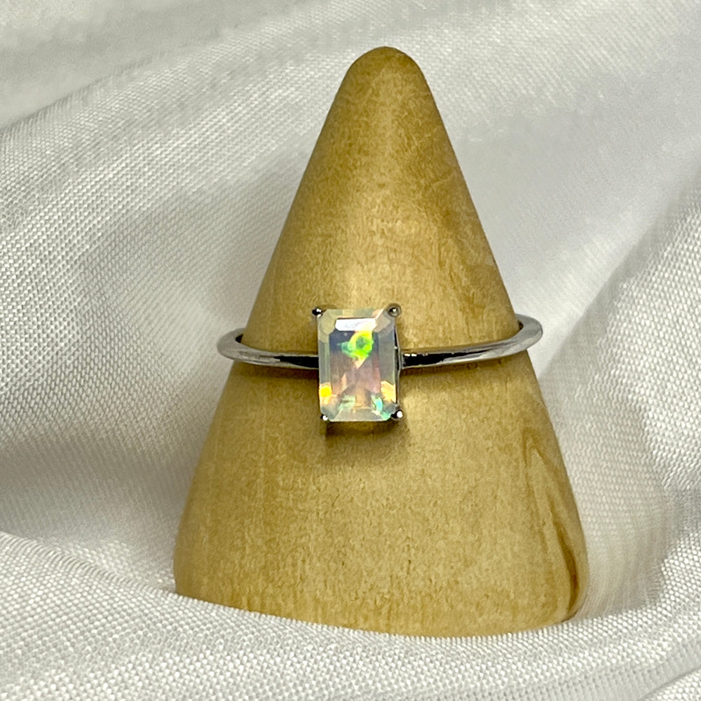 
                  
                    A Cushion Cut Ethiopian Opal ring displayed on top of a white cloth.
                  
                
