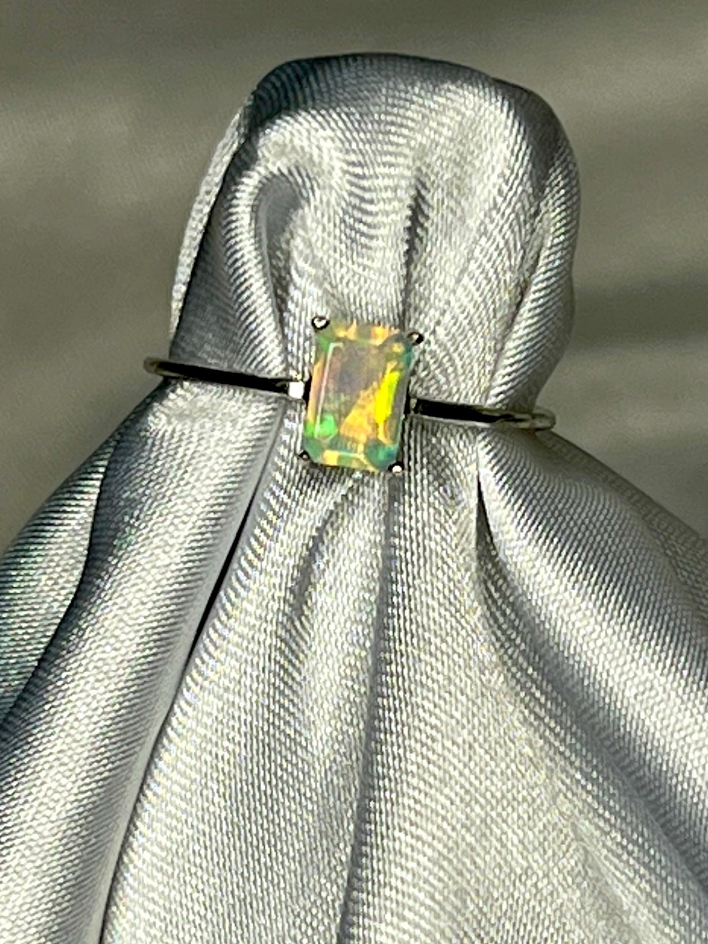 
                  
                    An elegant Cushion Cut Ethiopian Opal Ring with a statement green opal on it.
                  
                