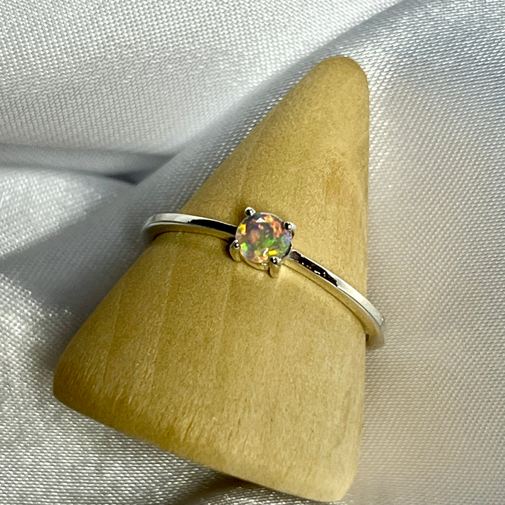 
                  
                    An elegant Dainty Prong Set Facet Cut Ethiopian Opal ring with an opal stone on top.
                  
                