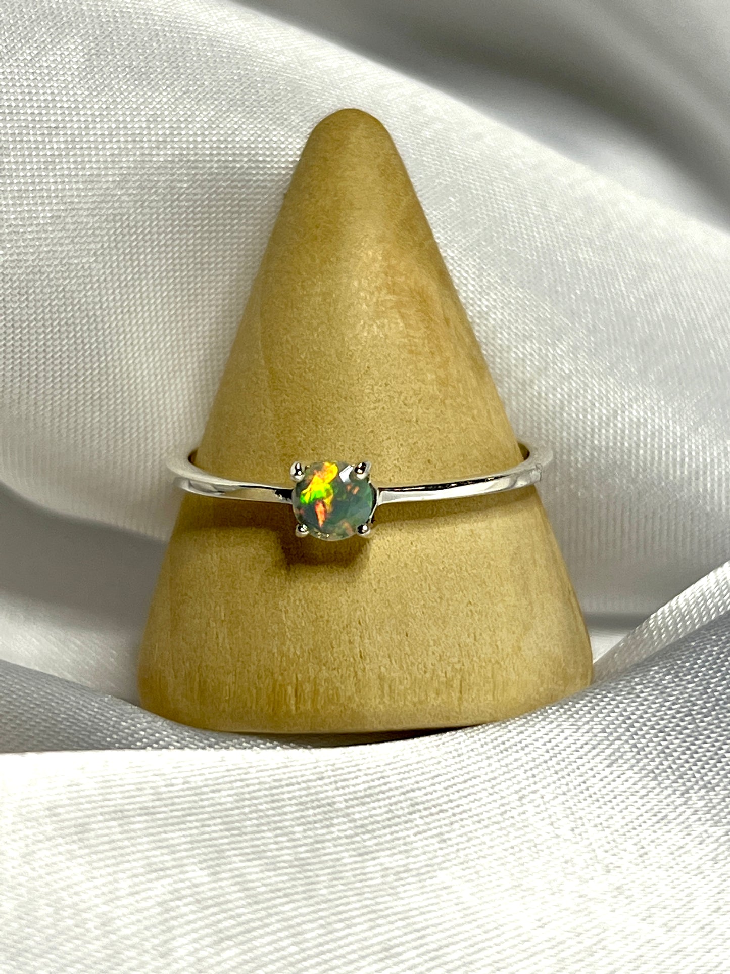 
                  
                    An elegant silver ring with a Dainty Prong Set Facet Cut Ethiopian Opal stone.
                  
                