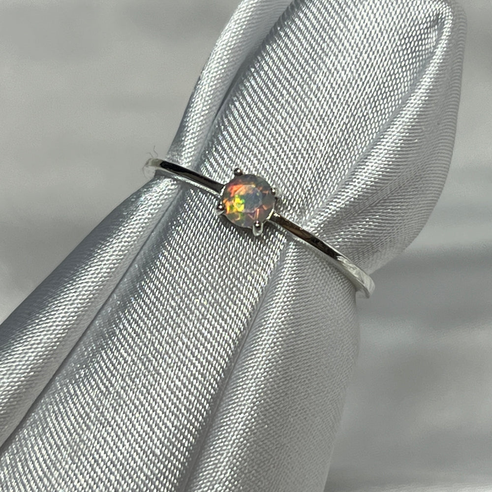 
                  
                    An elegant silver Dainty Prong Set Facet Cut Ethiopian Opal engagement ring with a captivating opal stone.
                  
                
