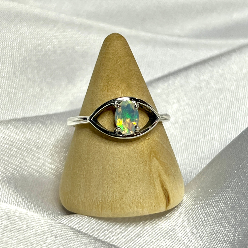 
                  
                    An elegant Facet Cut Ethiopian Opal Evil Eye Ring on a white background.
                  
                