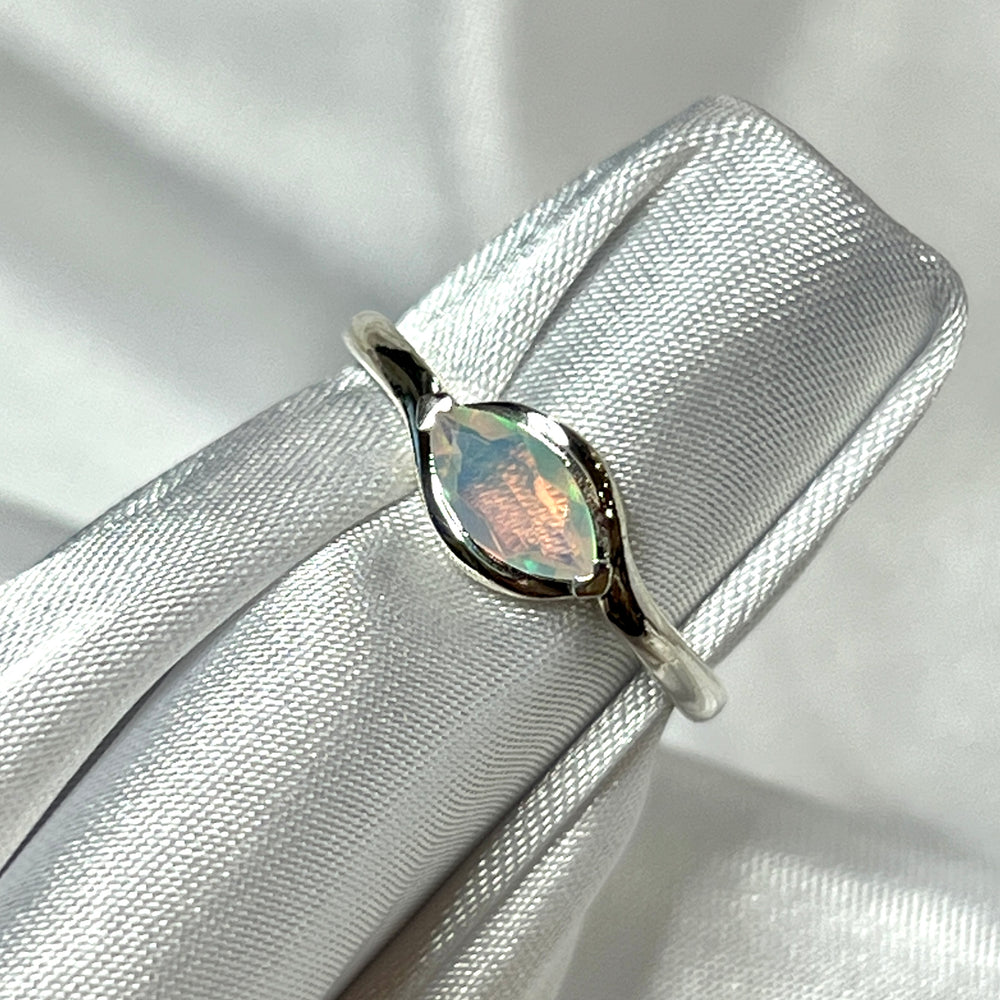 
                  
                    A stunning Brilliant Facet Cut Ethiopian Opal engagement ring placed delicately on a crisp white cloth, making a bold statement.
                  
                