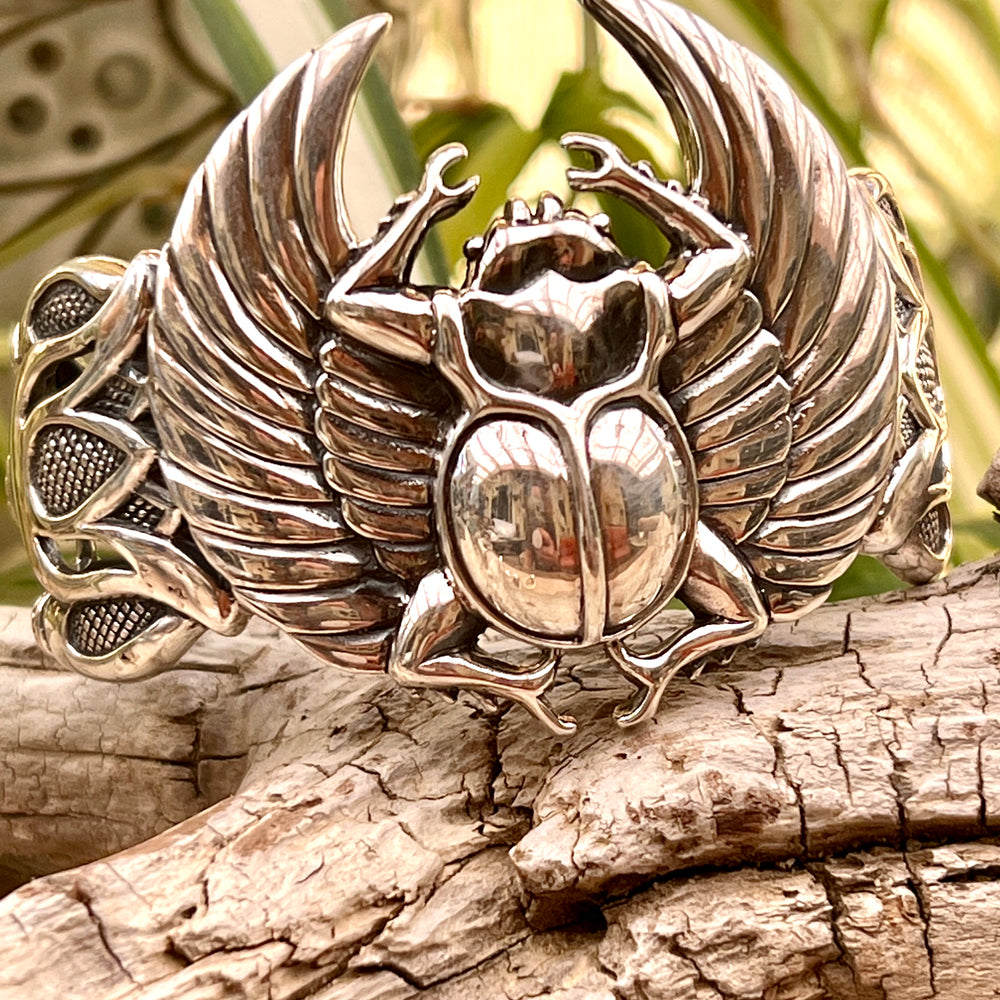 
                  
                    Super Silver Scarab with Wings cuff bracelet featuring a winged scarab and lotus flowers.
                  
                