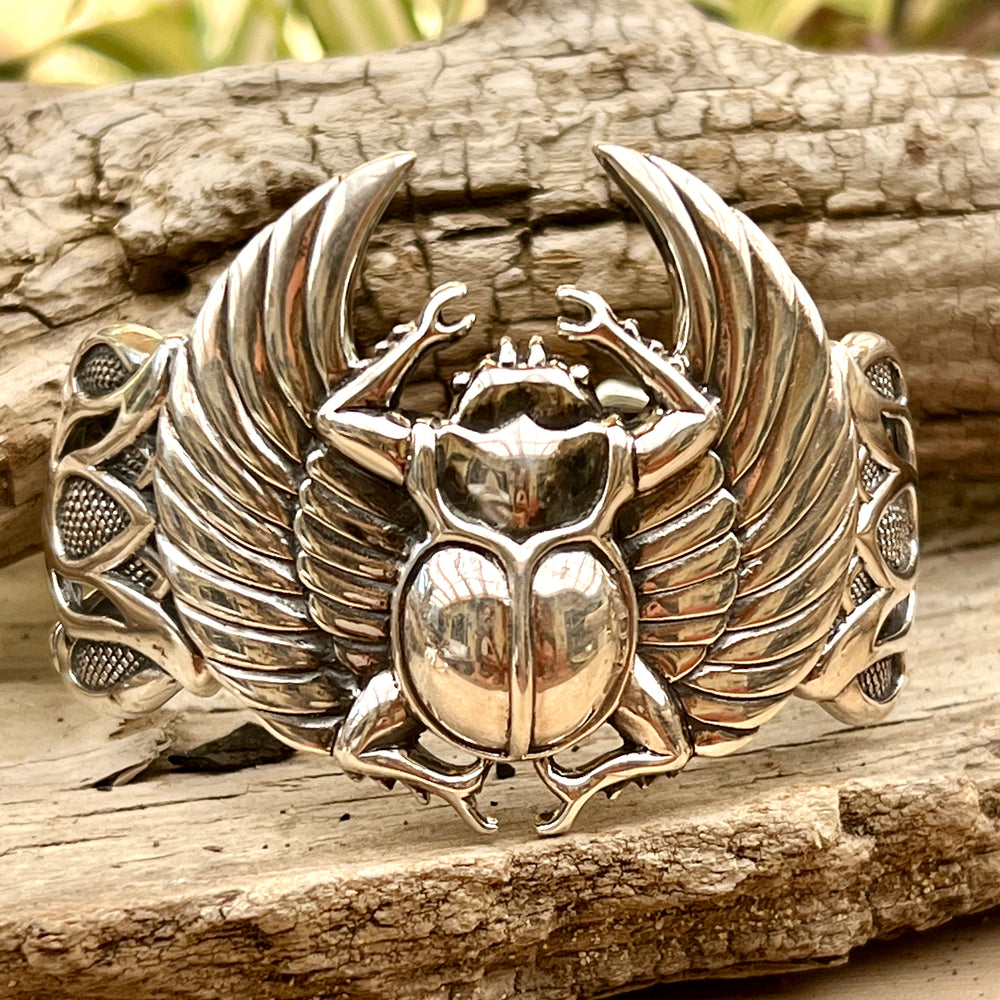 
                  
                    A Super Silver Scarab with Wings Cuff Bracelet with an Egyptian scarab beetle and lotus flowers.
                  
                