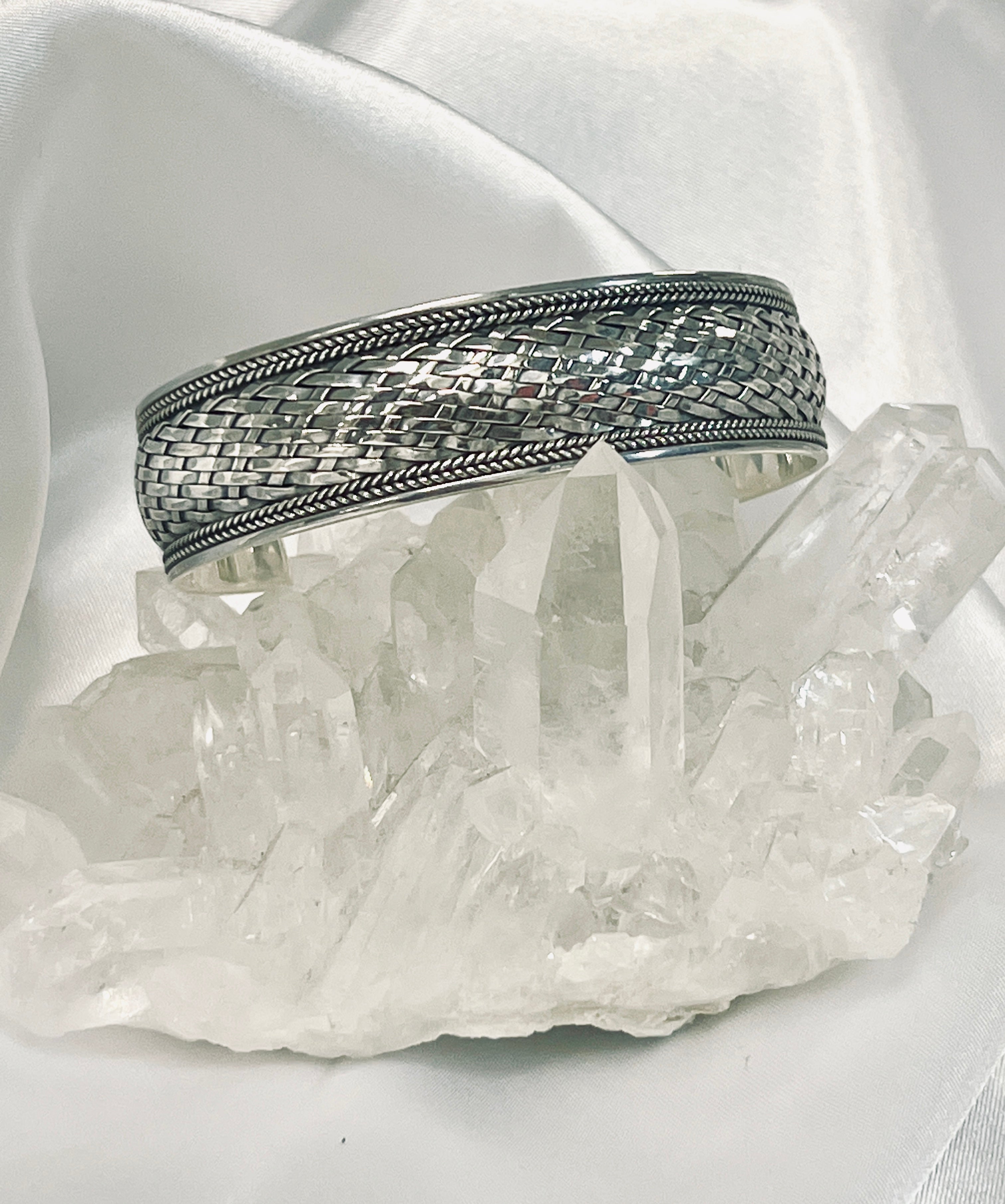 A Super Silver Woven Silver Cuff Bracelet embellished with oxidized basket weave, showcasing a statement cuff with crystals.