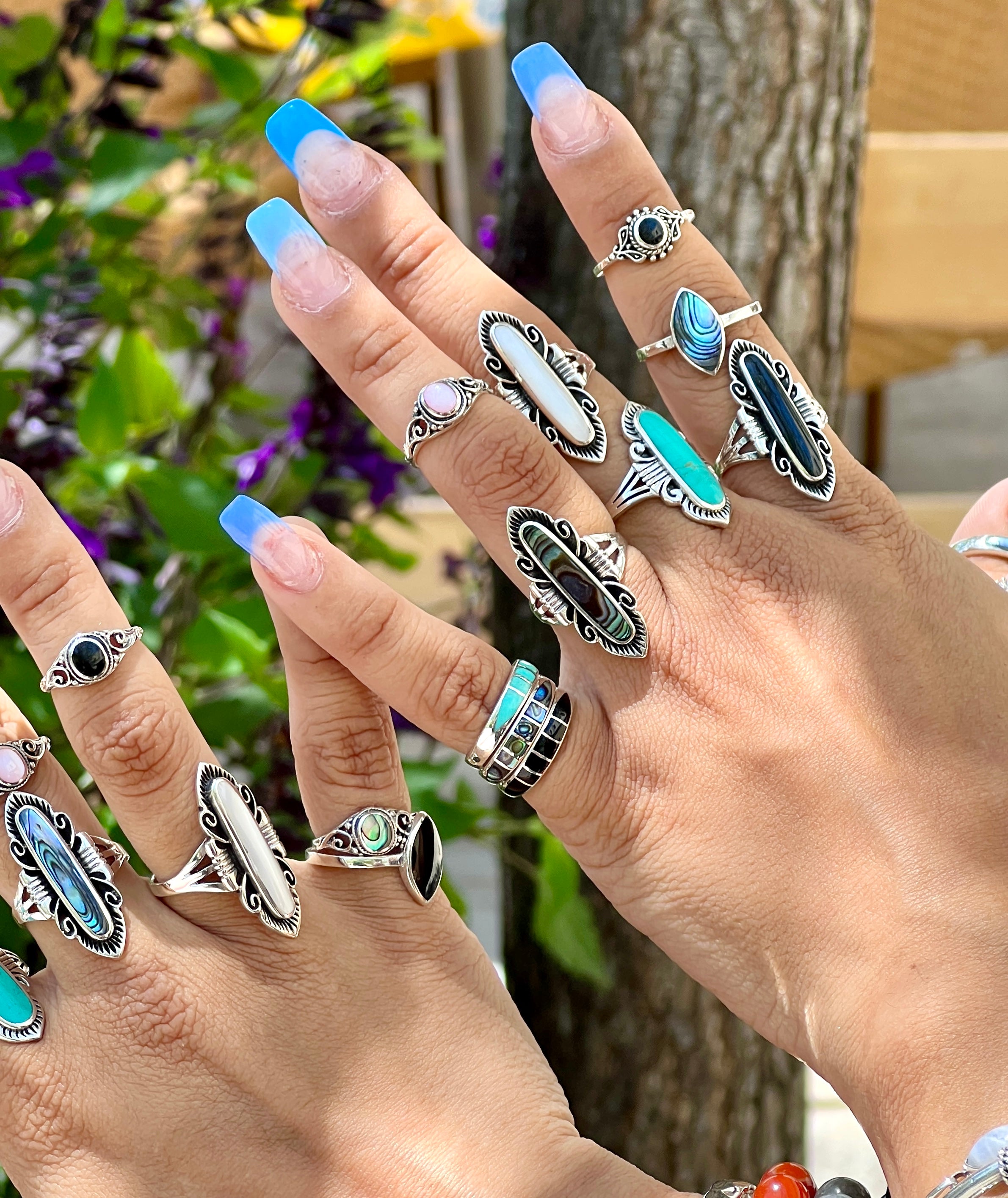 A woman's hands adorned with Super Silver's Elegant Southwest Inspired Ring with Inlaid Stone.