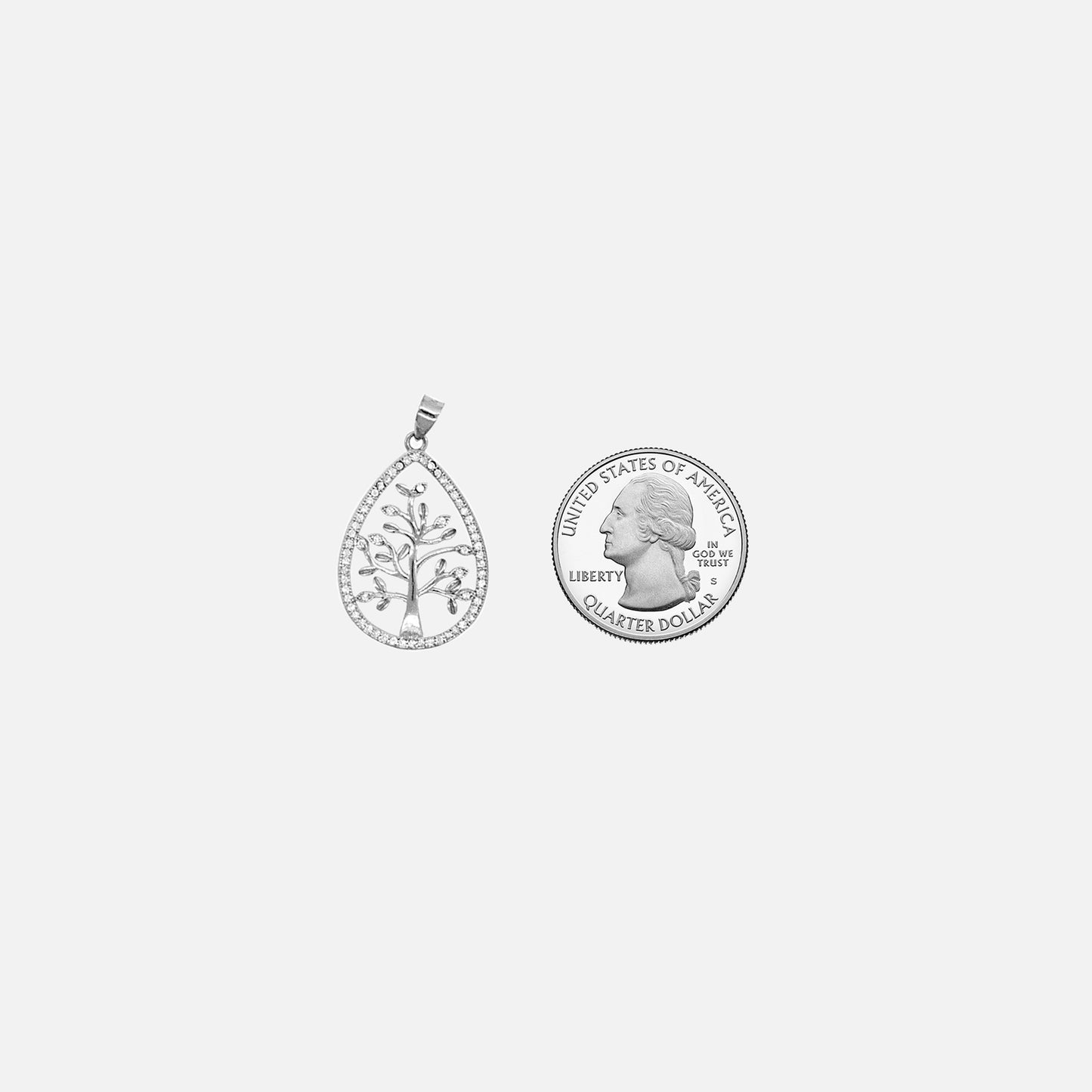A Super Silver Brilliant CZ Tree of Life pendant next to a quarter.
