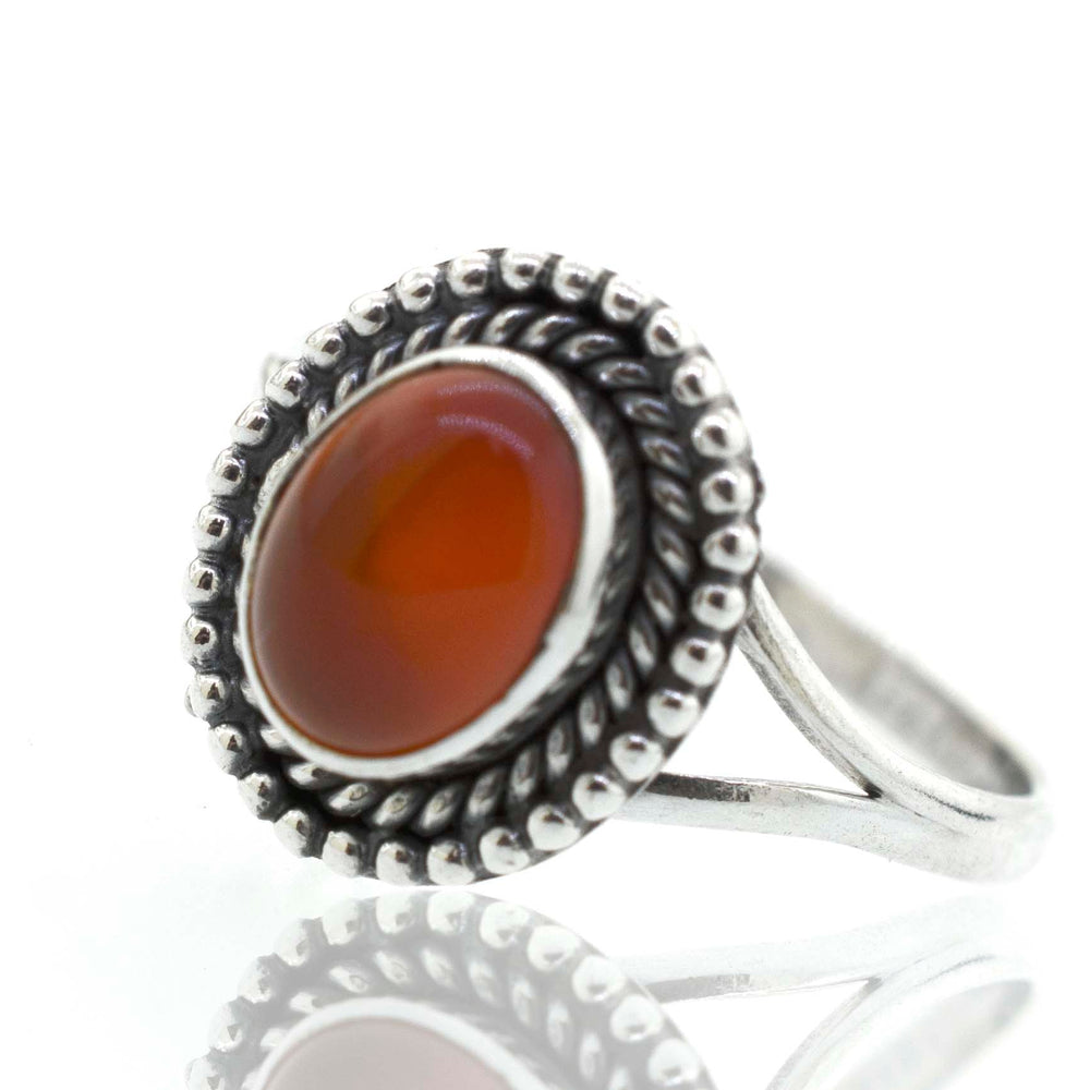 
                  
                    A boho silver Gemstone Oval Shield Ring with a cabochon orange stone.
                  
                