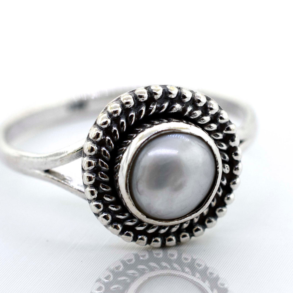 
                  
                    A Vintage Super Silver Gemstone Oval Shield Ring with a pearl gemstone at the center.
                  
                