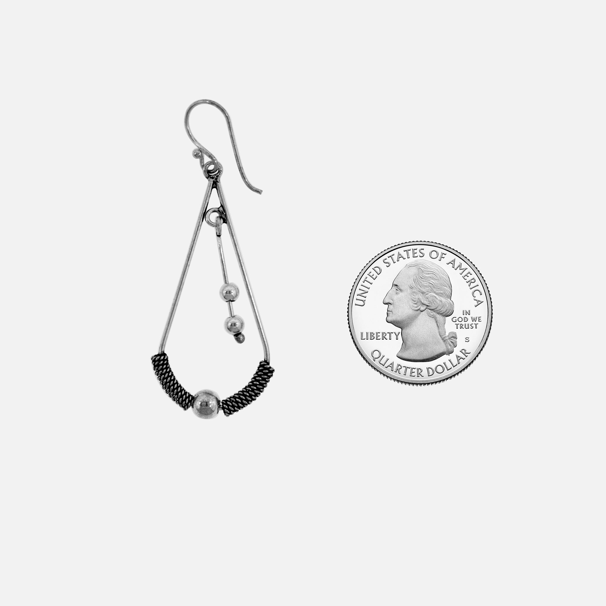 A Super Silver Bali Teardrop Earrings with Tassel collection of earrings with a coin next to them.