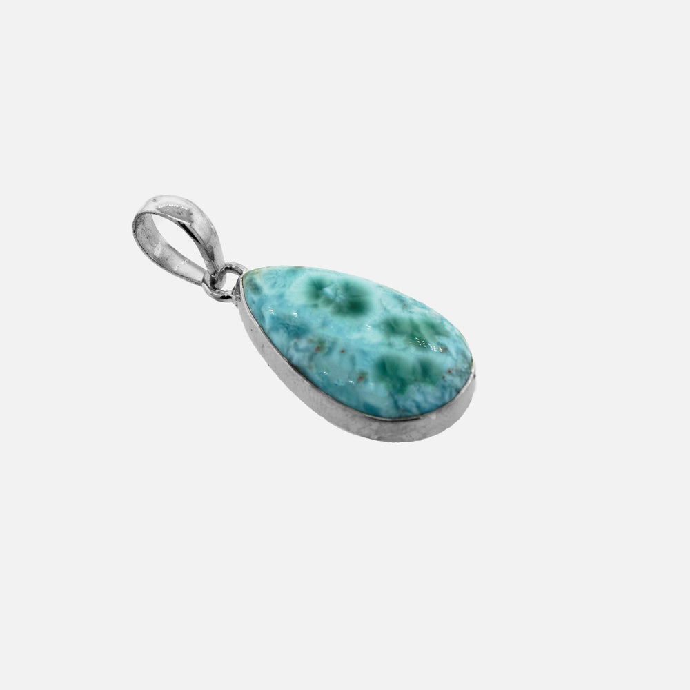 A Medium Larimar Teardrop Pendant in sterling silver, adding shine to any outfit.