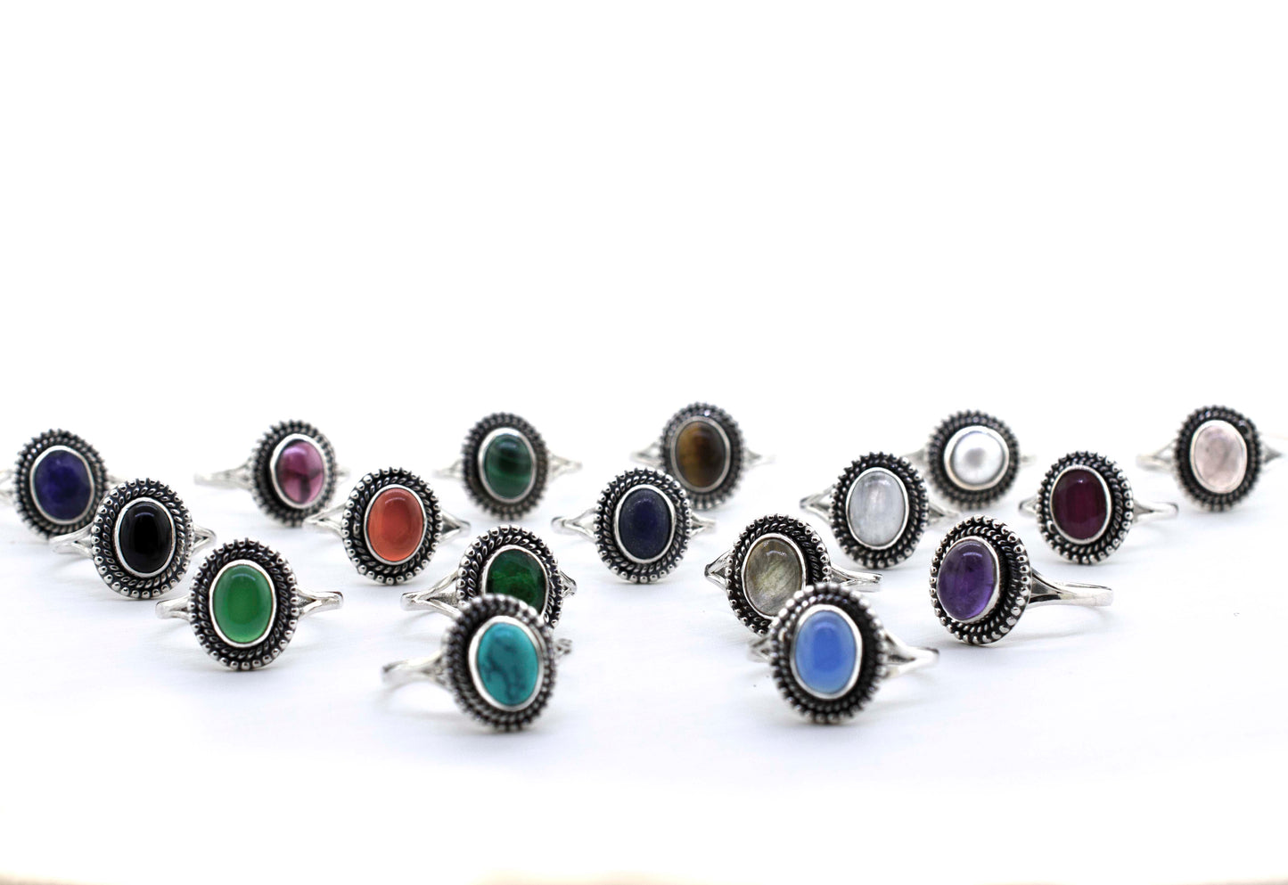 A group of colorful Gemstone Oval Shield Rings on a white background.