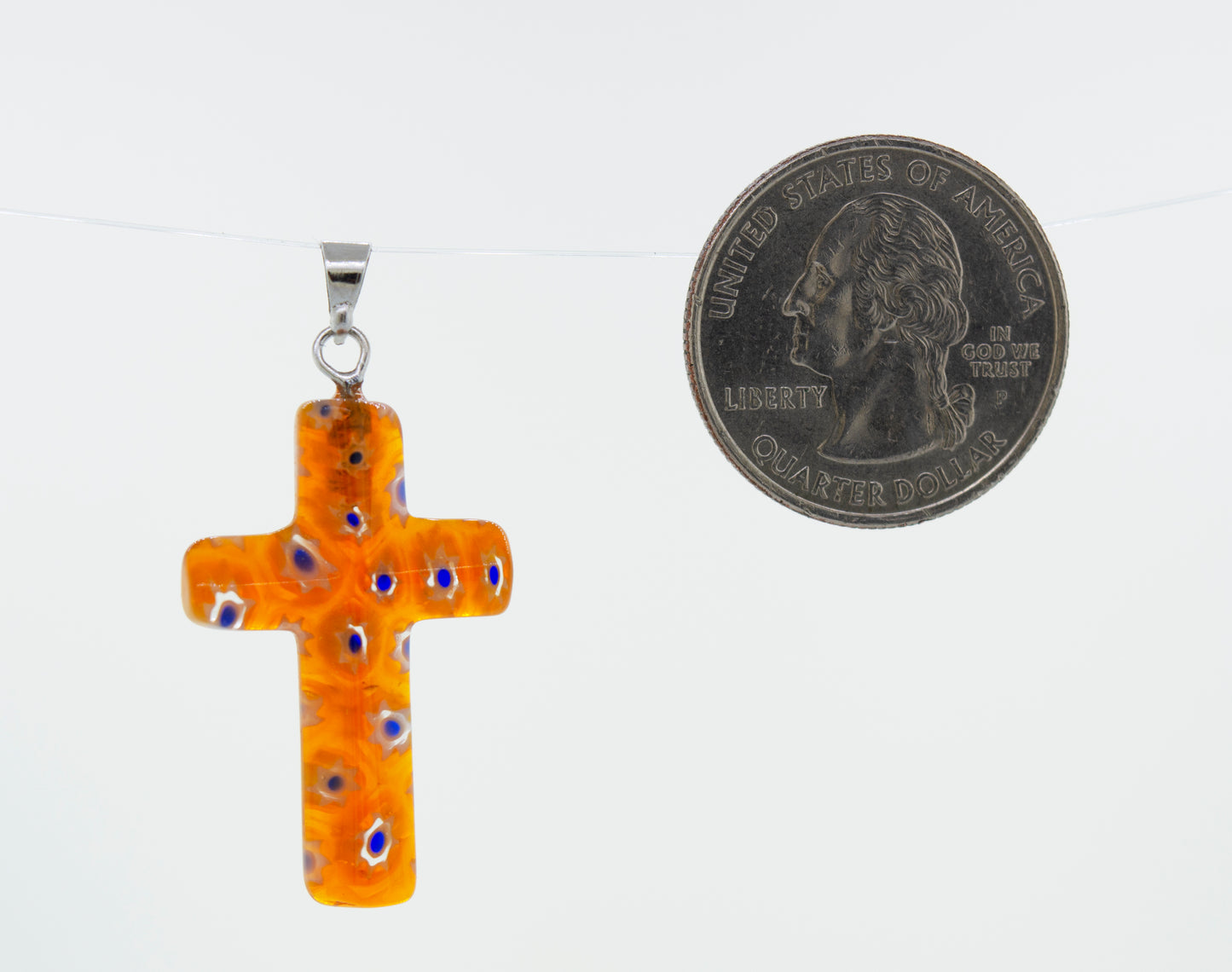 
                  
                    A Super Silver Cross Pendant with Flower Pattern adorned with a delicate flower pattern, placed next to a dime.
                  
                