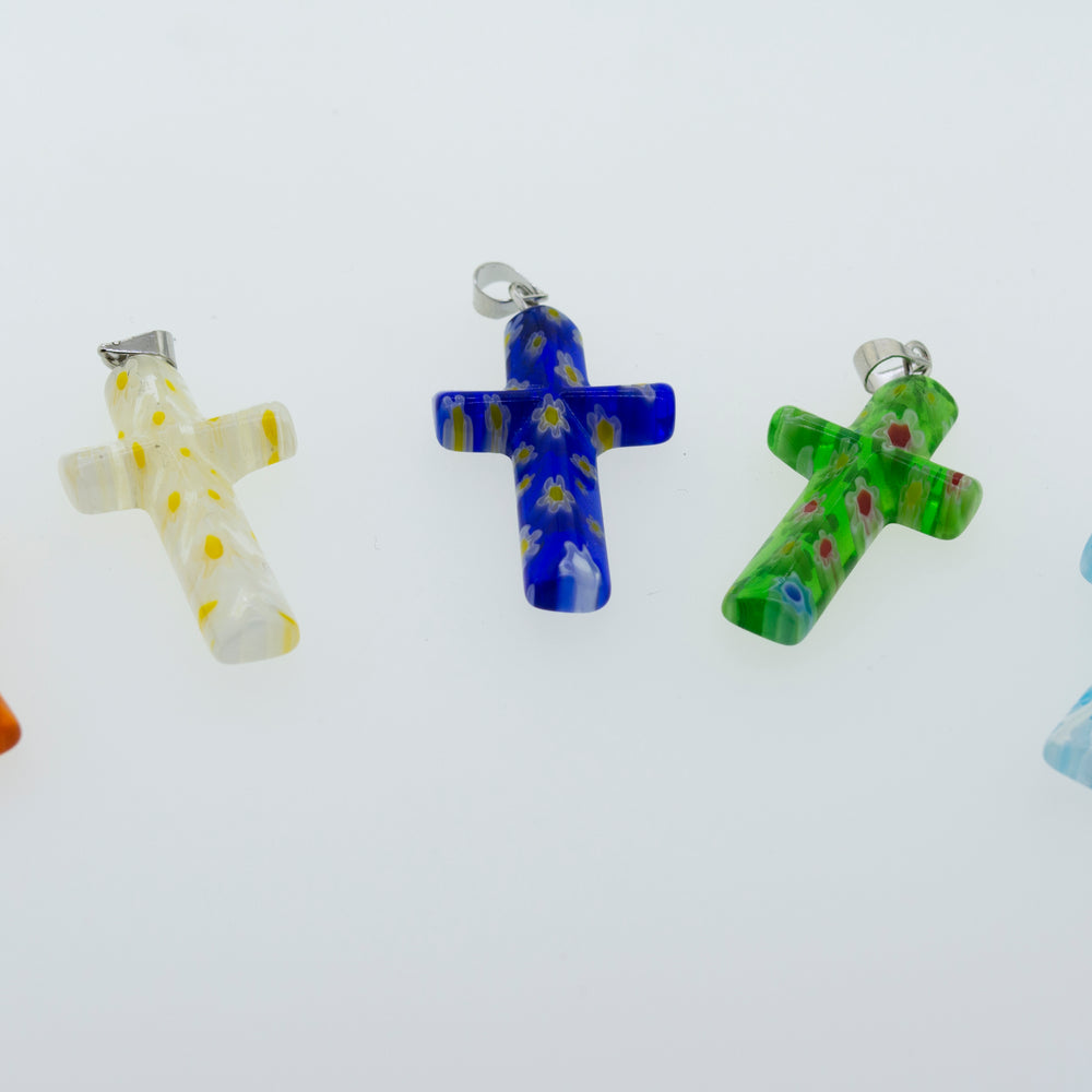 A group of vibrant Super Silver Cross Pendants with Flower Pattern made of translucent resin on a white surface.